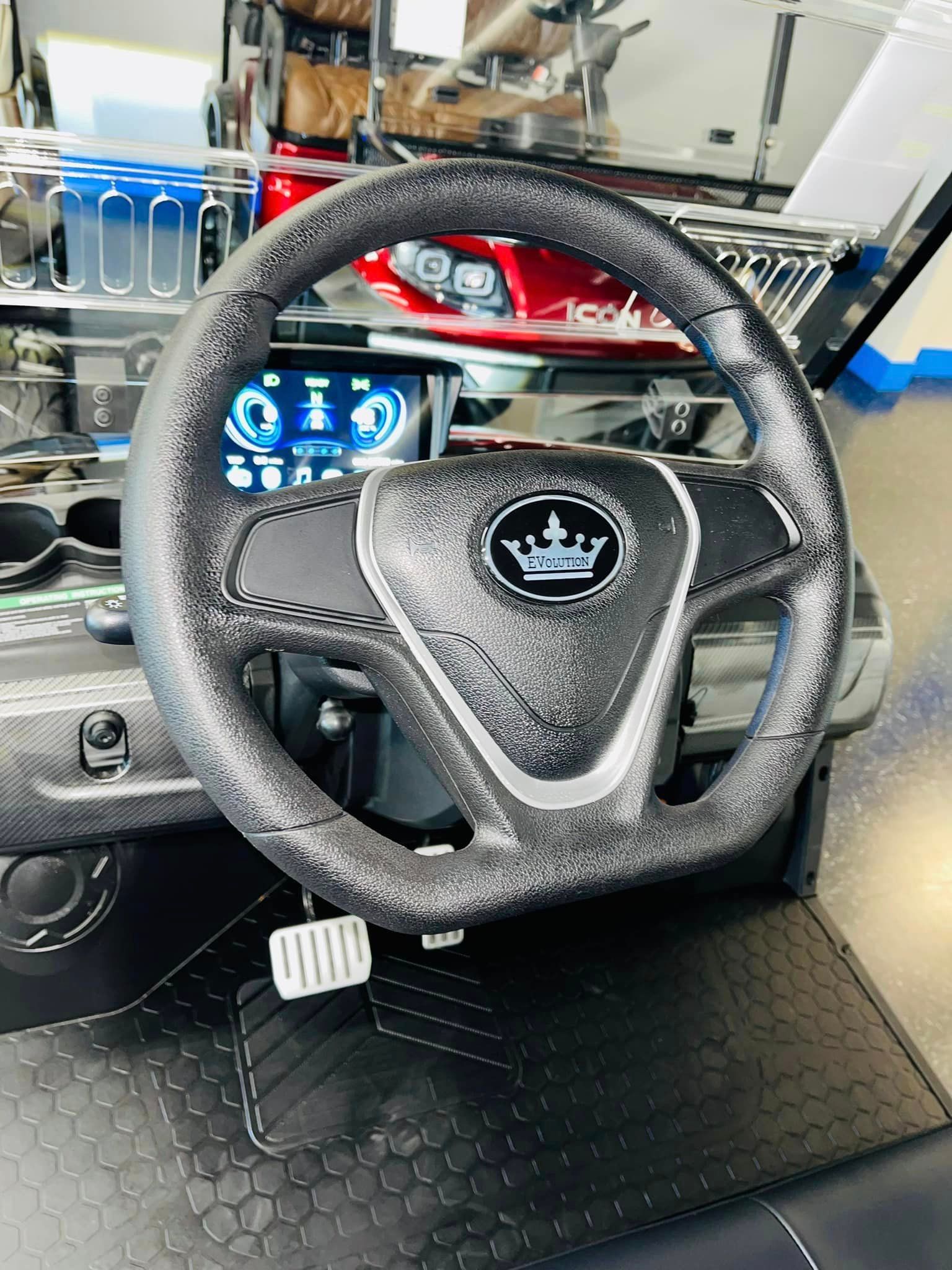 A close up of a steering wheel on a golf cart.