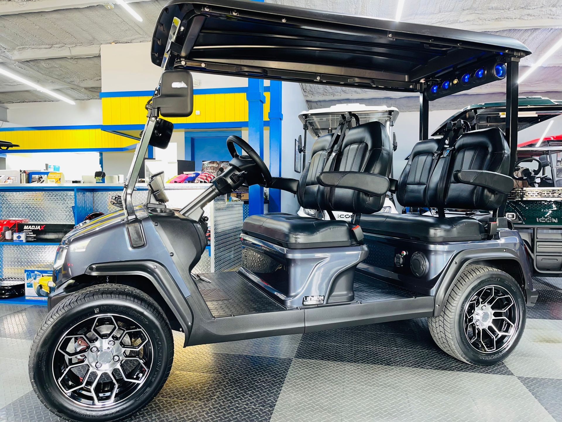 A black golf cart is parked in a garage.