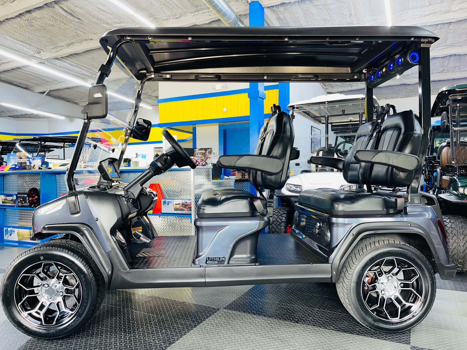 A golf cart is parked in a showroom.