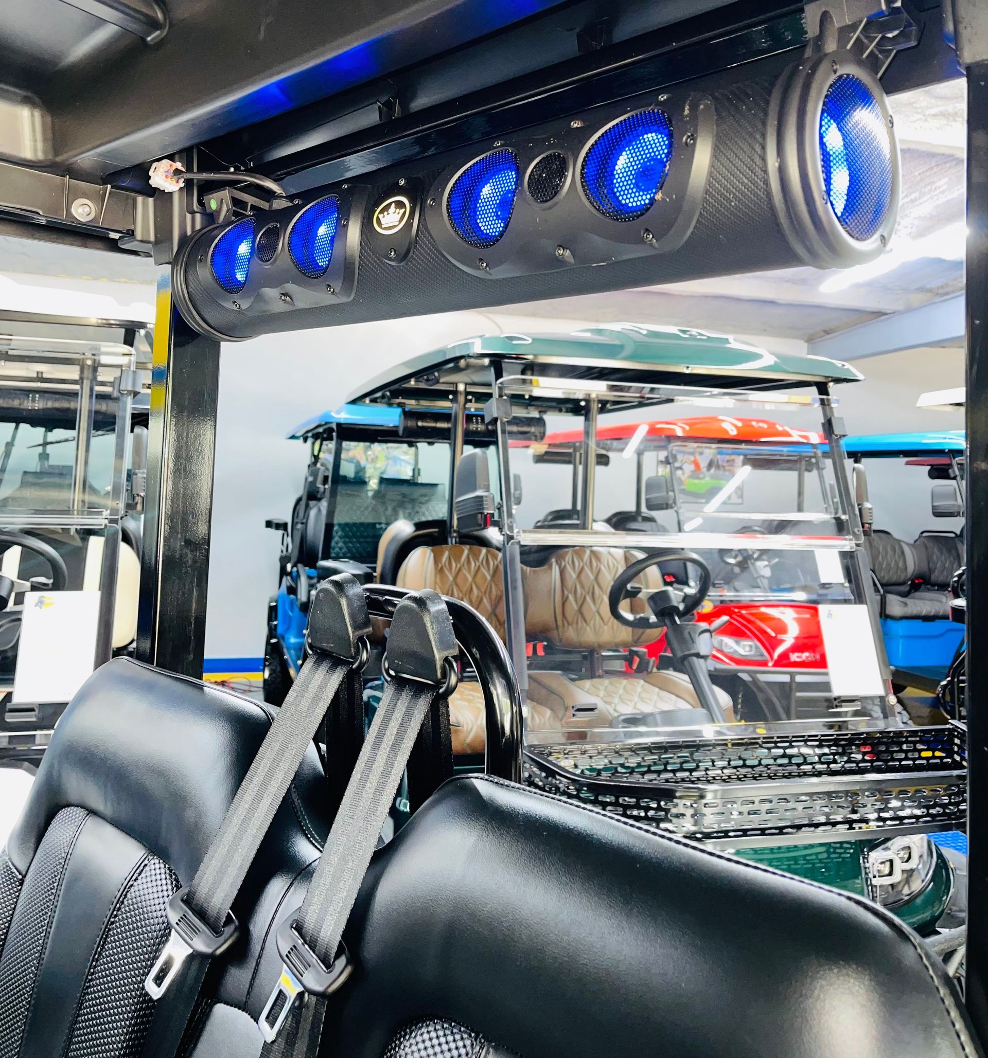 A golf cart with a speaker on top of it