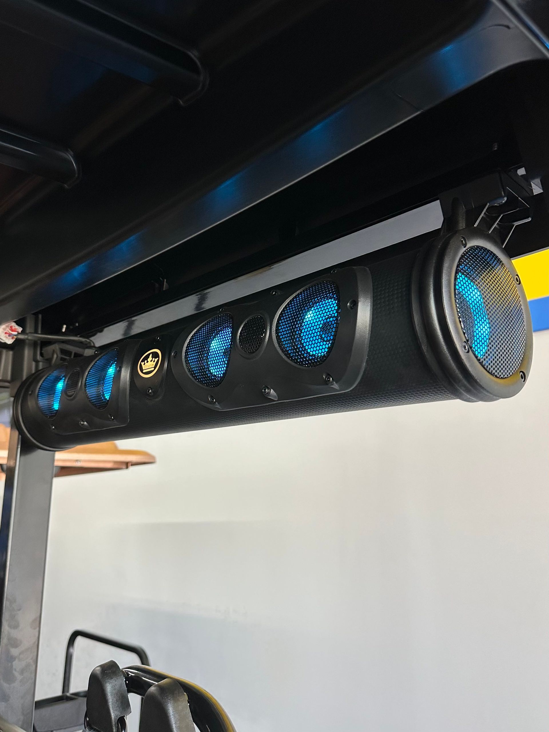 A blue light is hanging from the ceiling of a vehicle