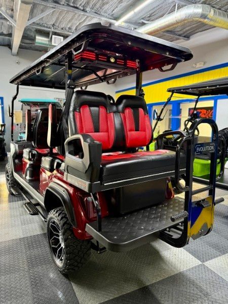 A red and black golf cart is parked in a garage