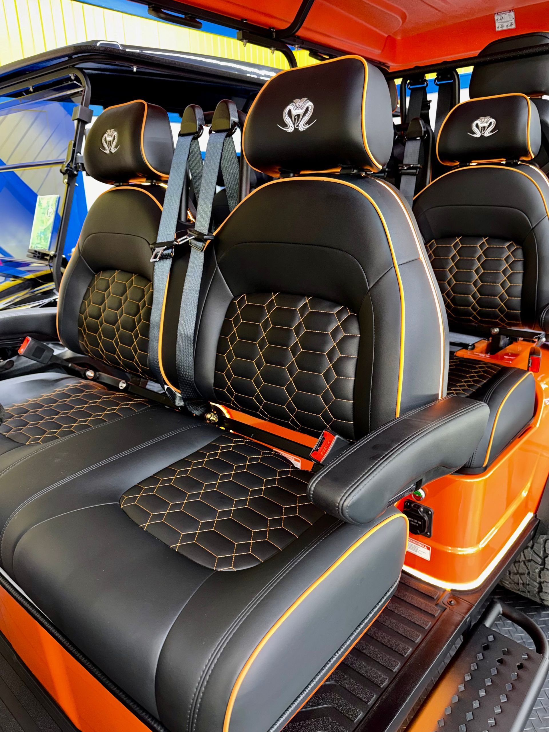 Black and orange custom truck interior with quilted leather seats and headrests