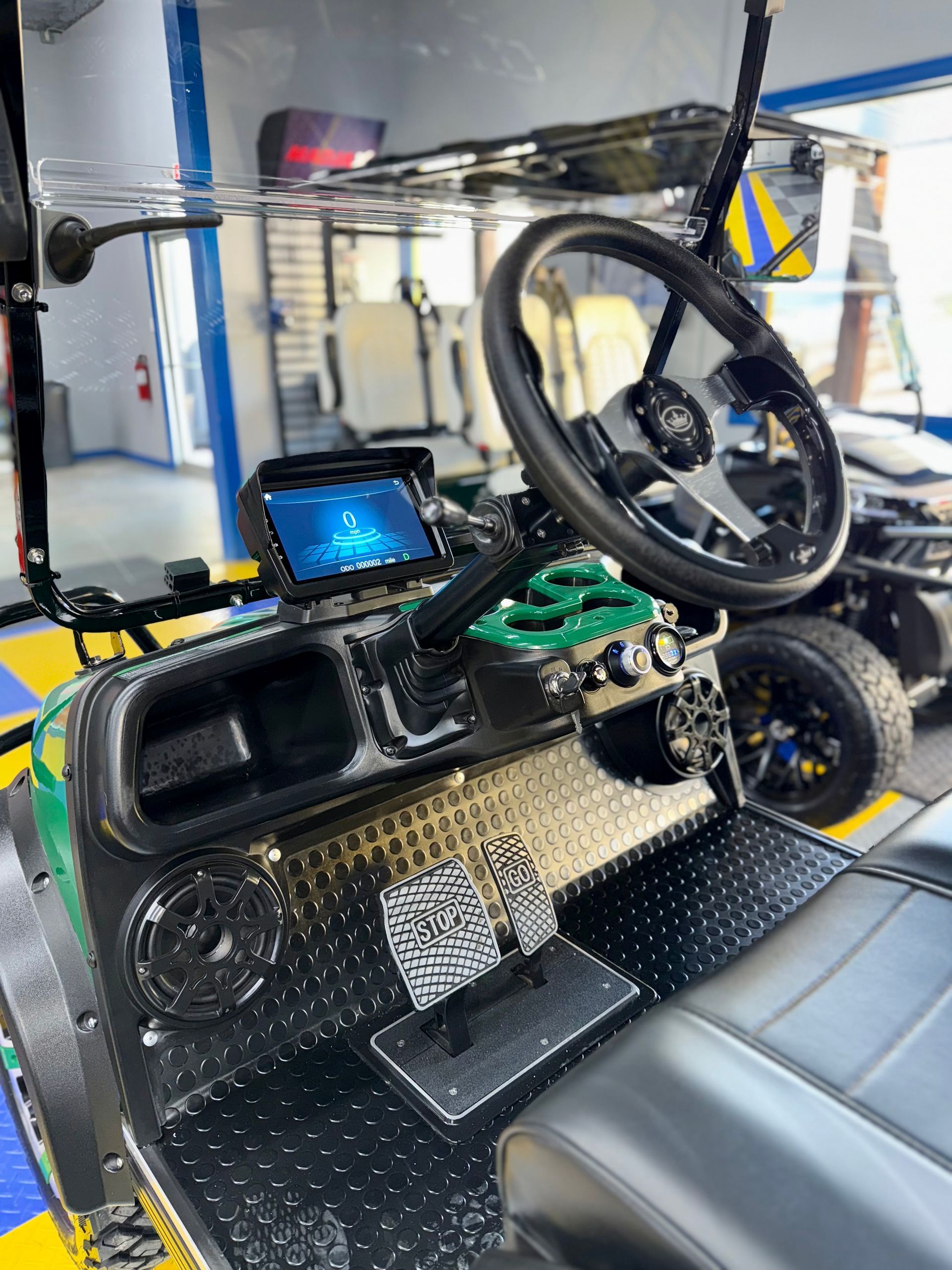 The inside of a golf cart with a steering wheel