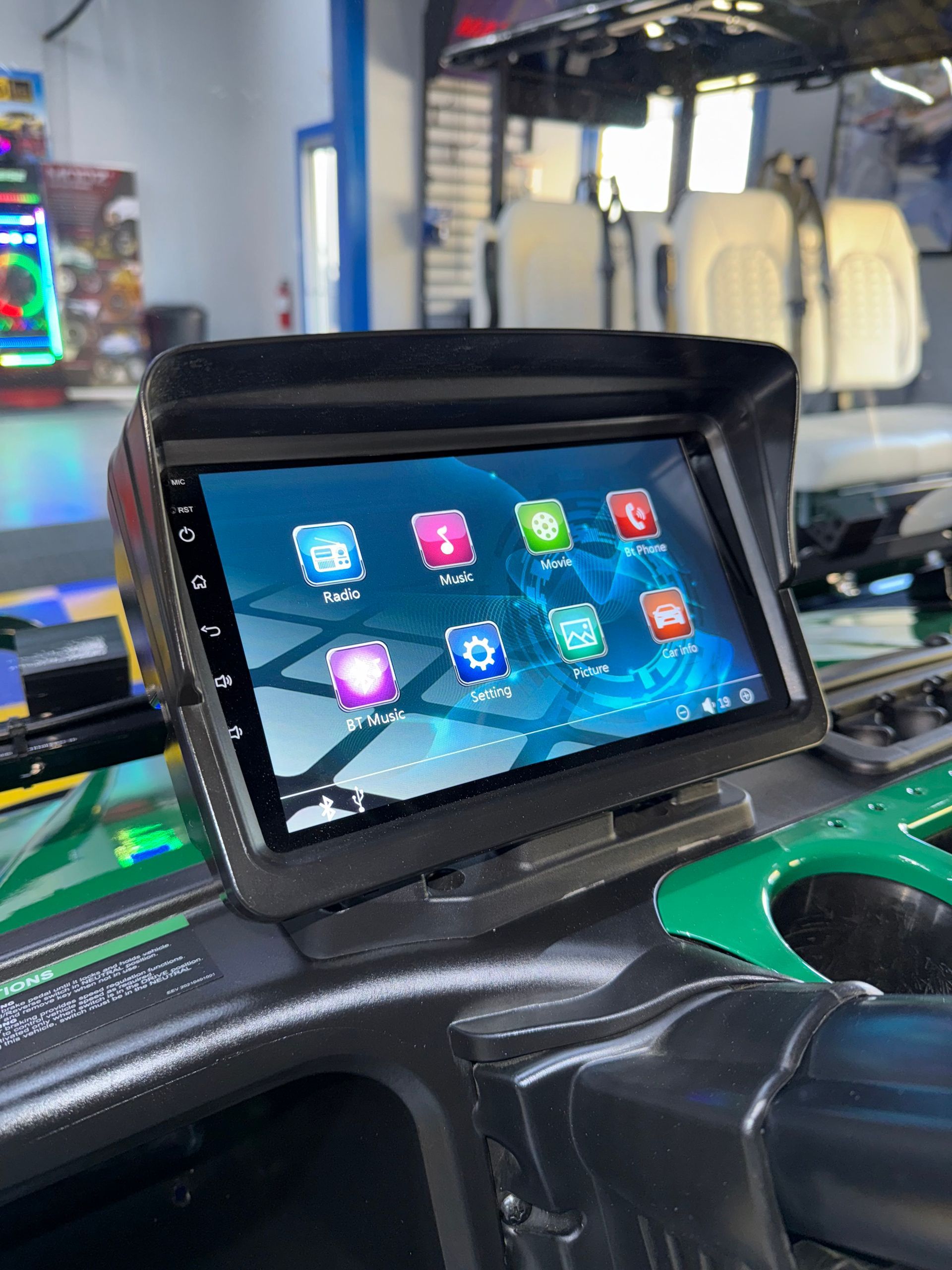A car dashboard with a tablet on top of it.