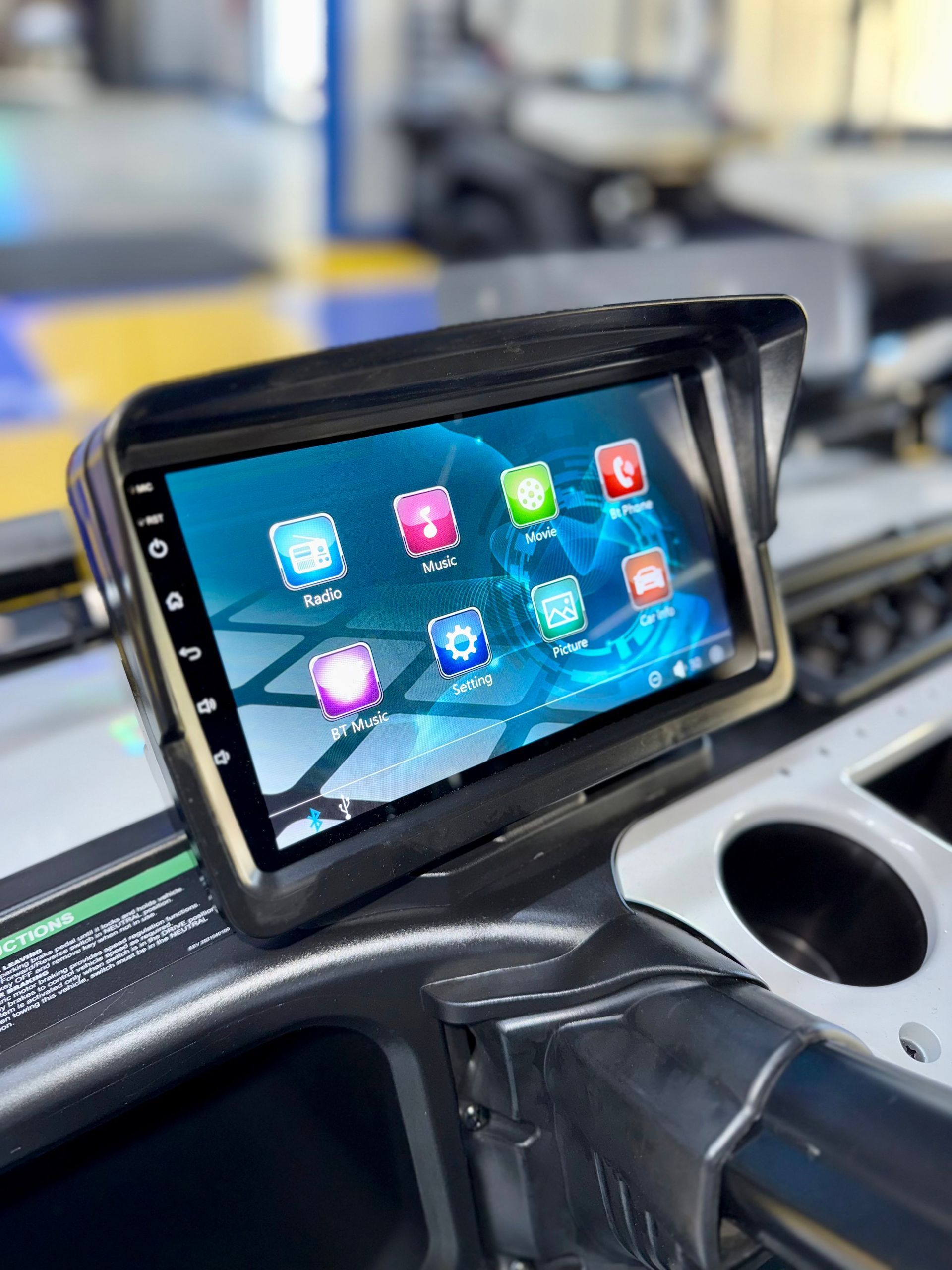A tablet is sitting on the dashboard of a car.