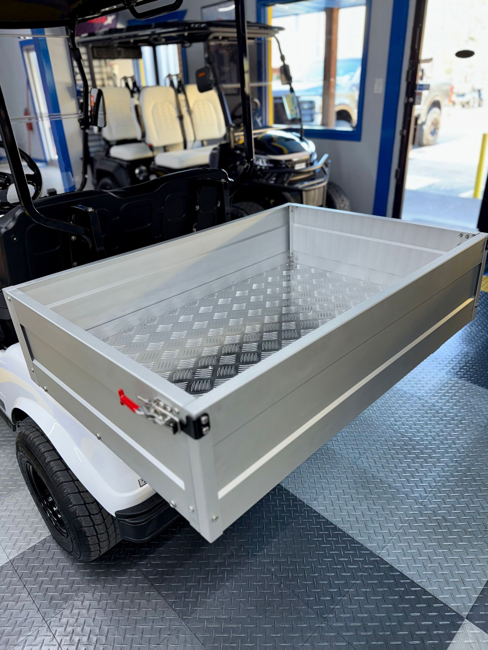 A golf cart with a tray attached to it