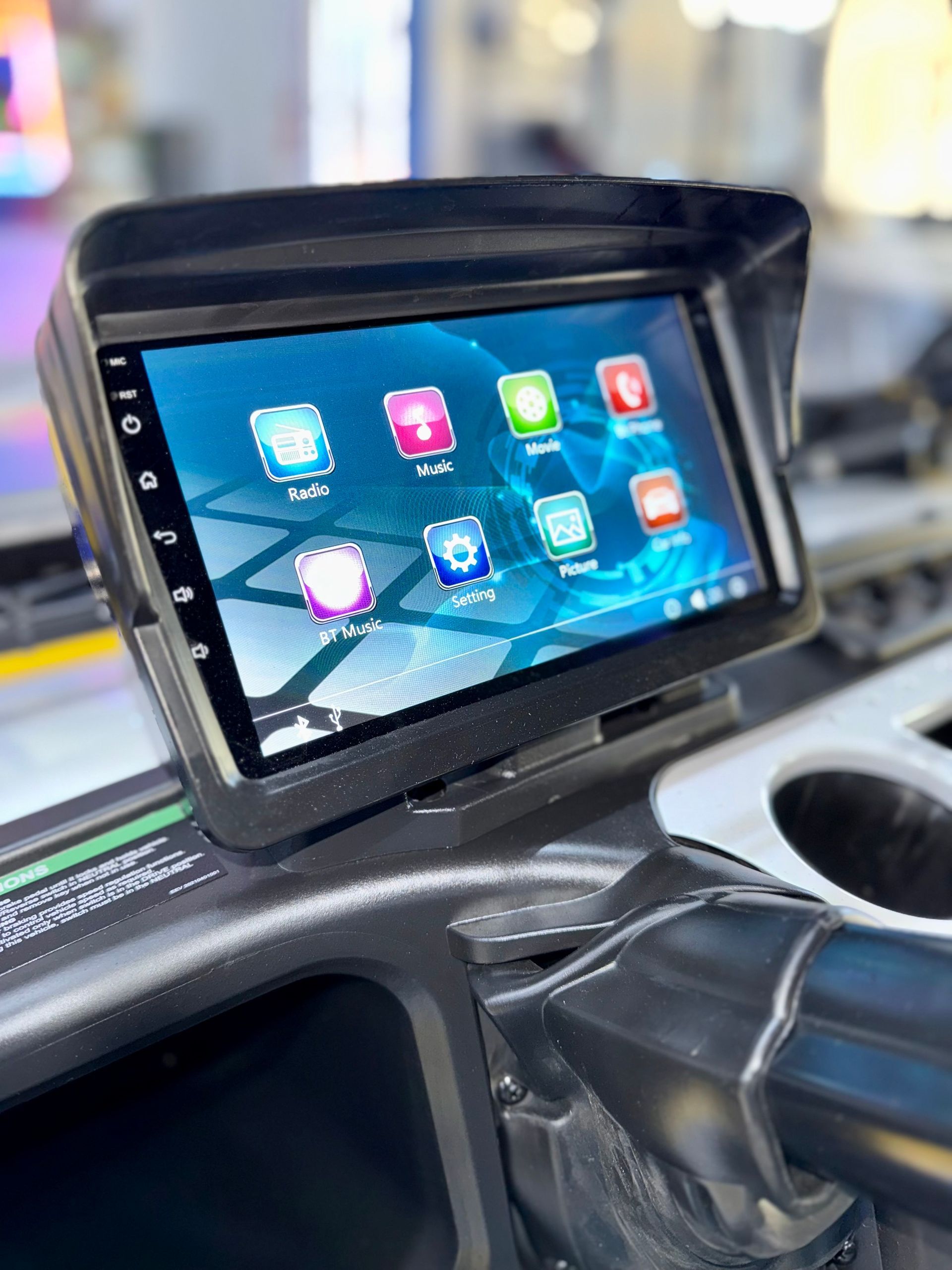 A tablet is sitting on the dashboard of a car.