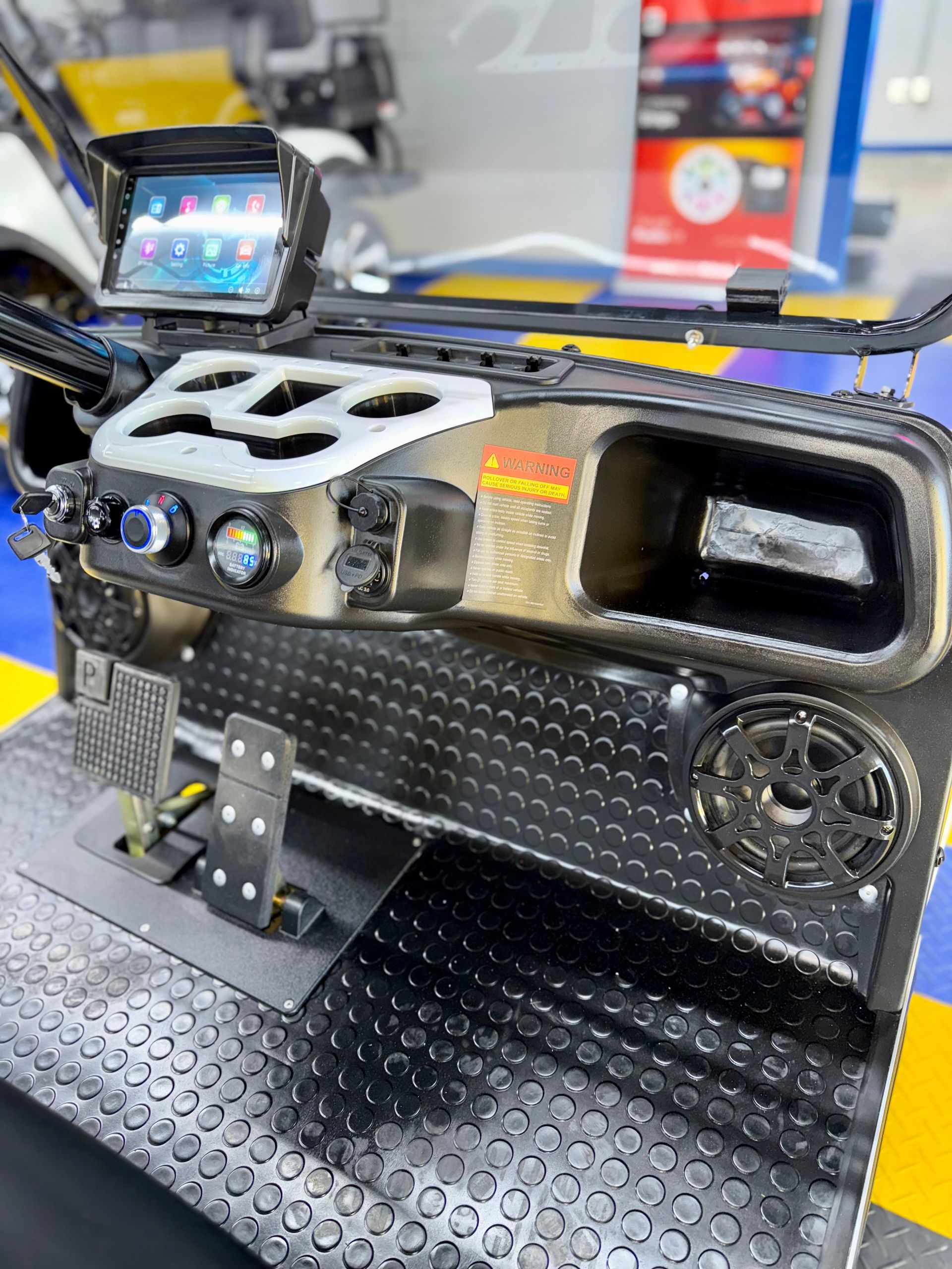 The dashboard of a golf cart is sitting on a table.