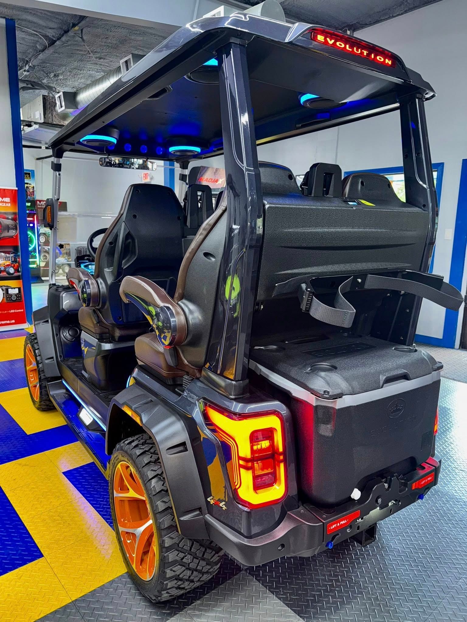 A black golf cart is parked in a garage.