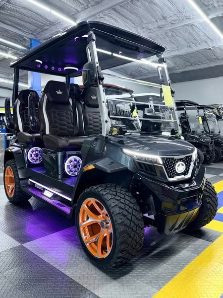 A black golf cart is parked in a showroom.