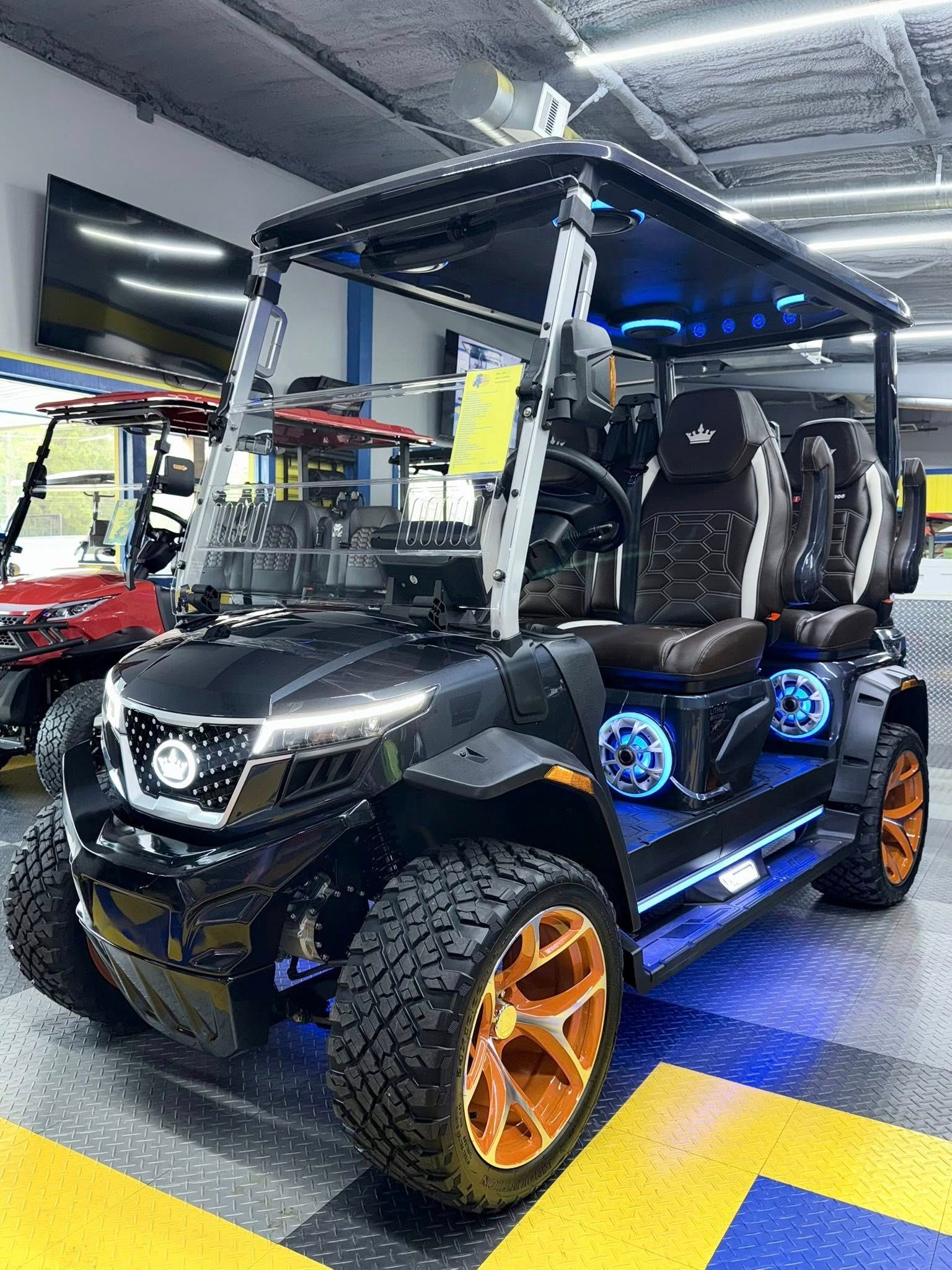 A black golf cart is parked in a showroom.