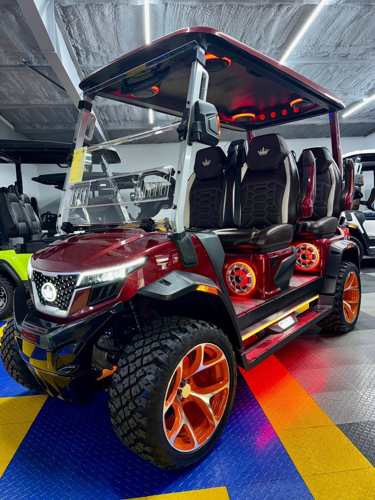 A red golf cart is parked in a showroom.