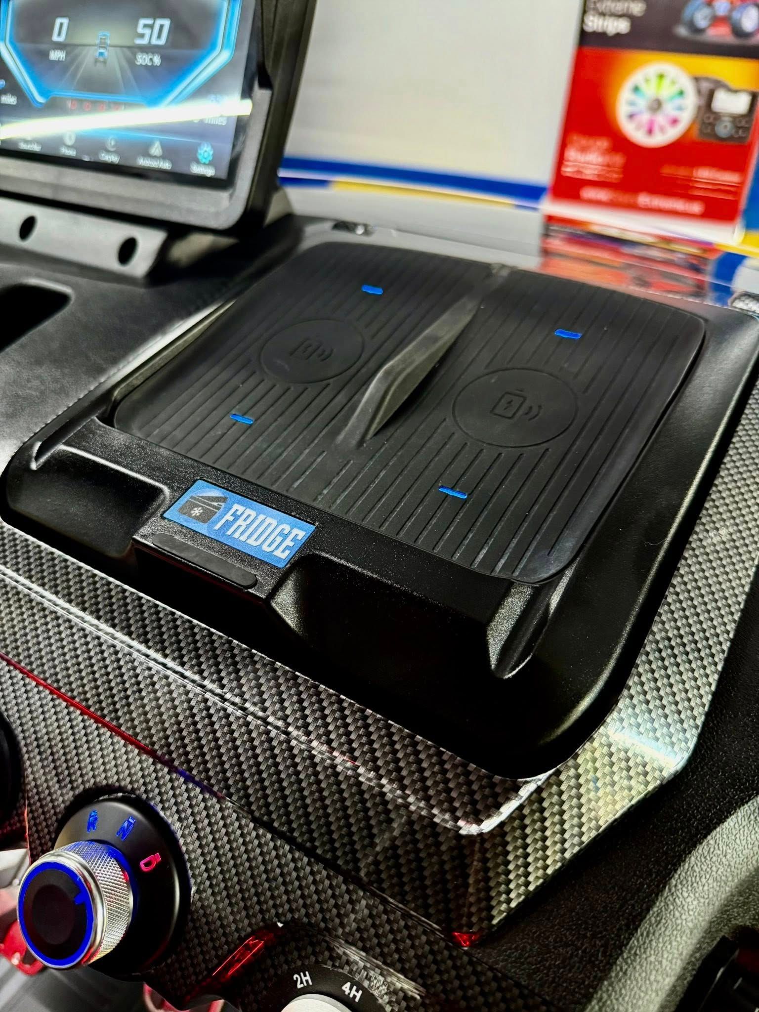 A wireless charger is sitting on the dashboard of a car.