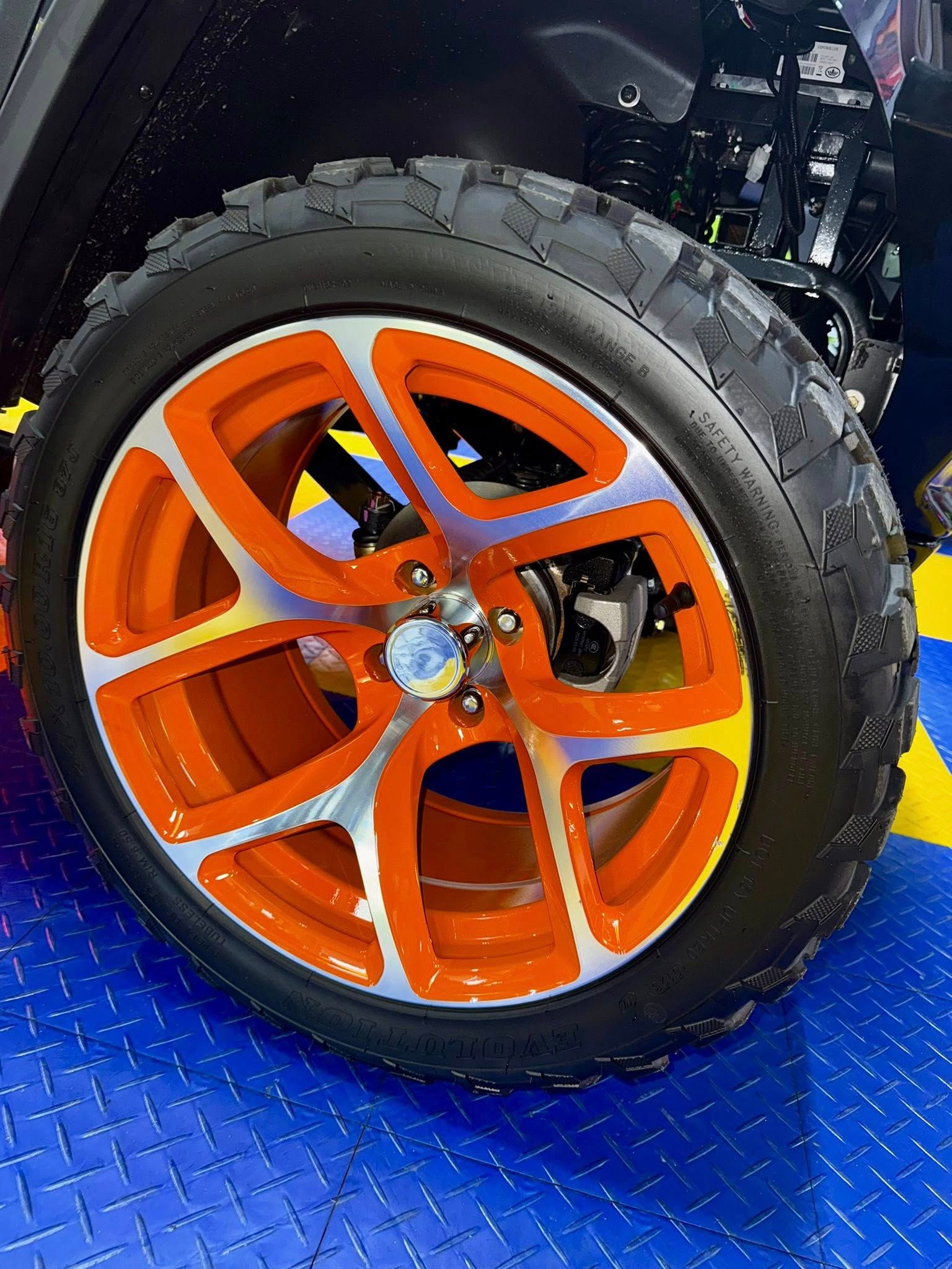 A close up of an orange wheel on a jeep.