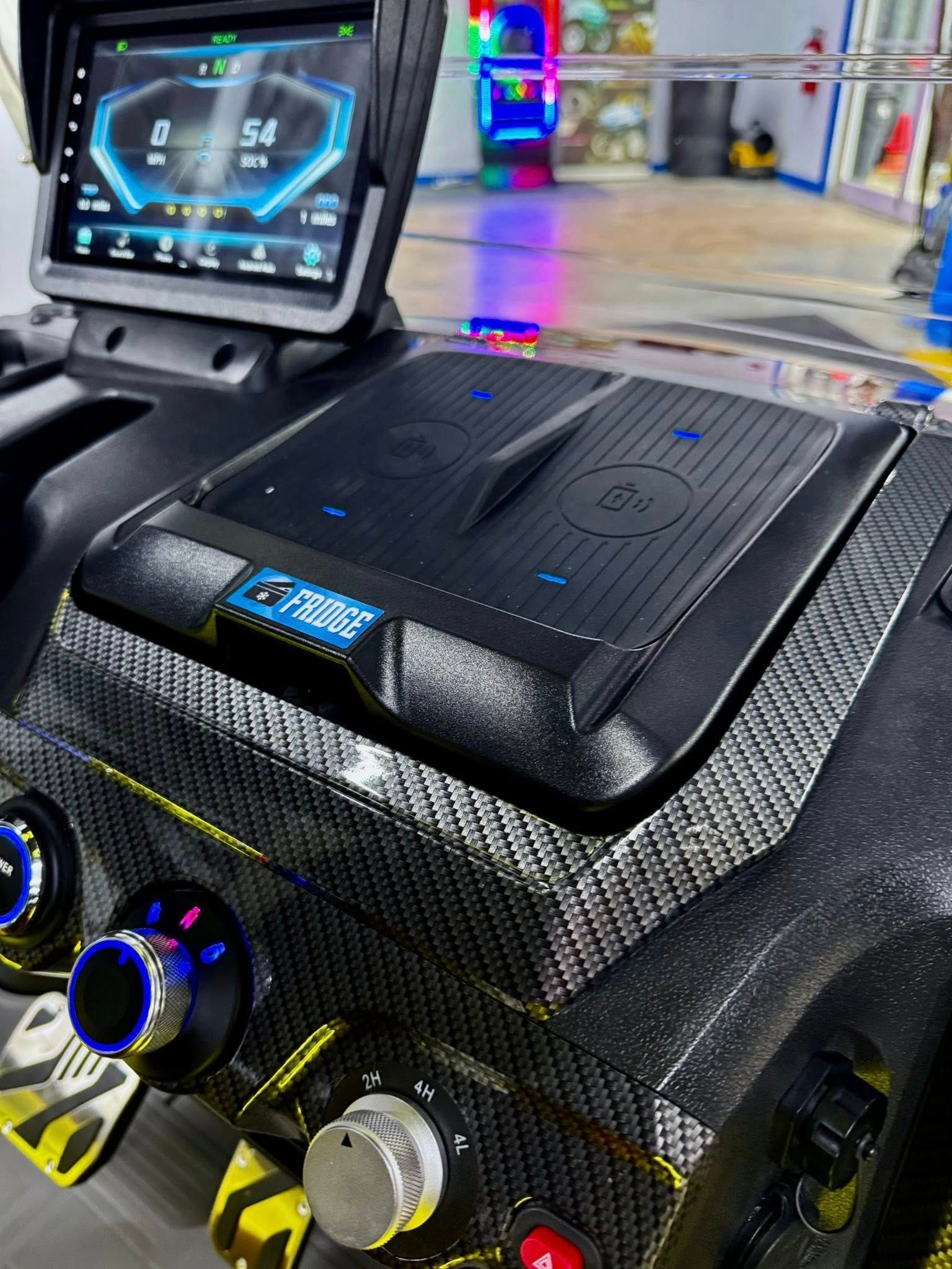 A close up of a car dashboard with a screen and buttons