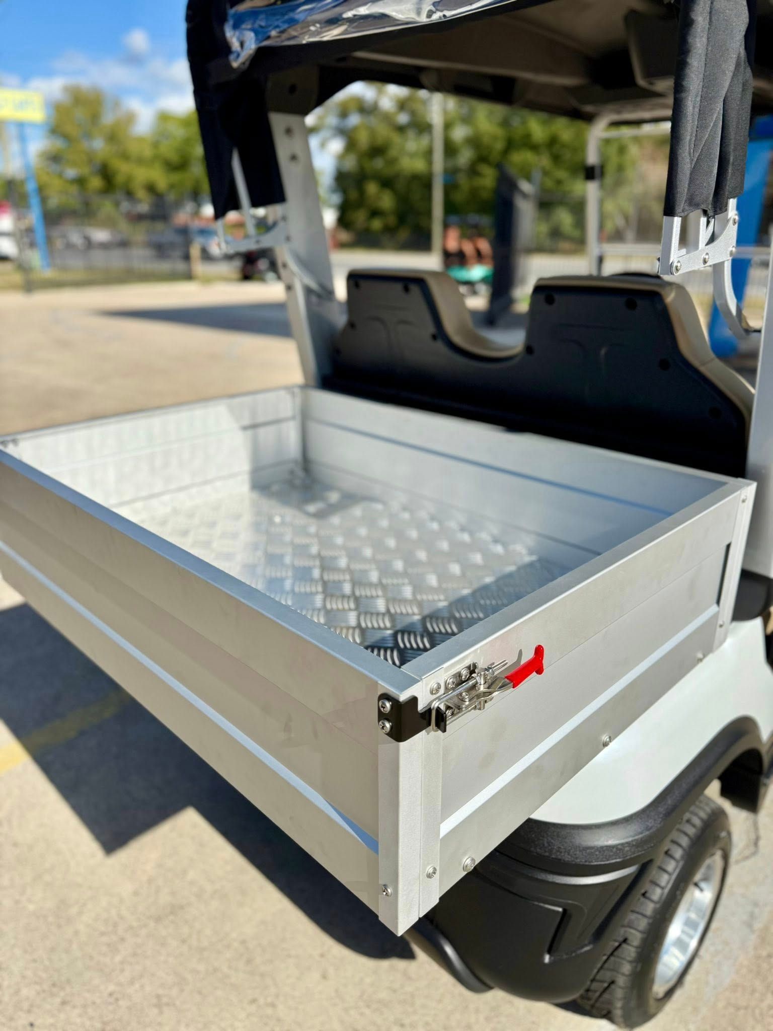 Golf cart with an aluminum cargo bed.