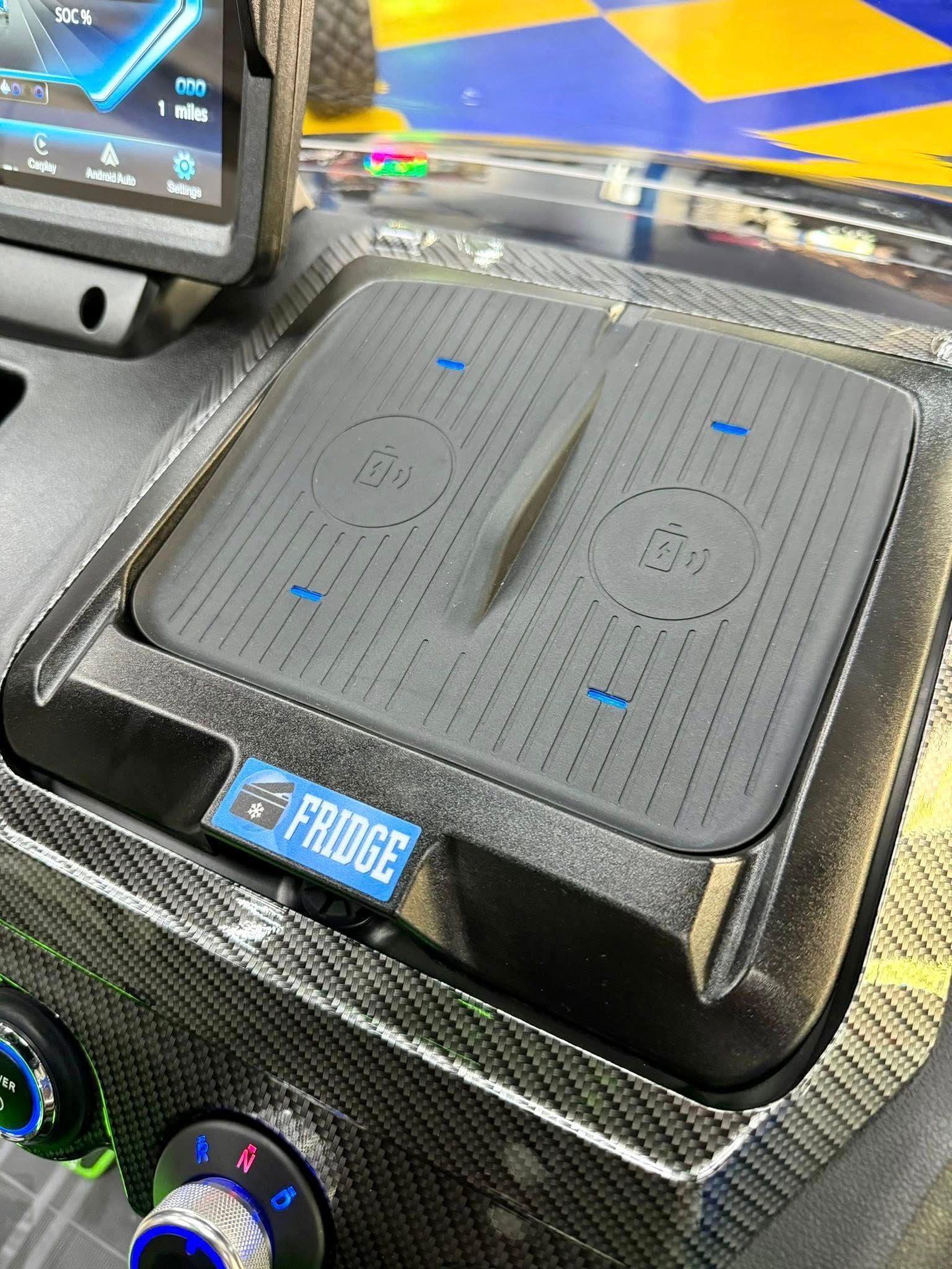 A close up of a wireless charger on the dashboard of a car.