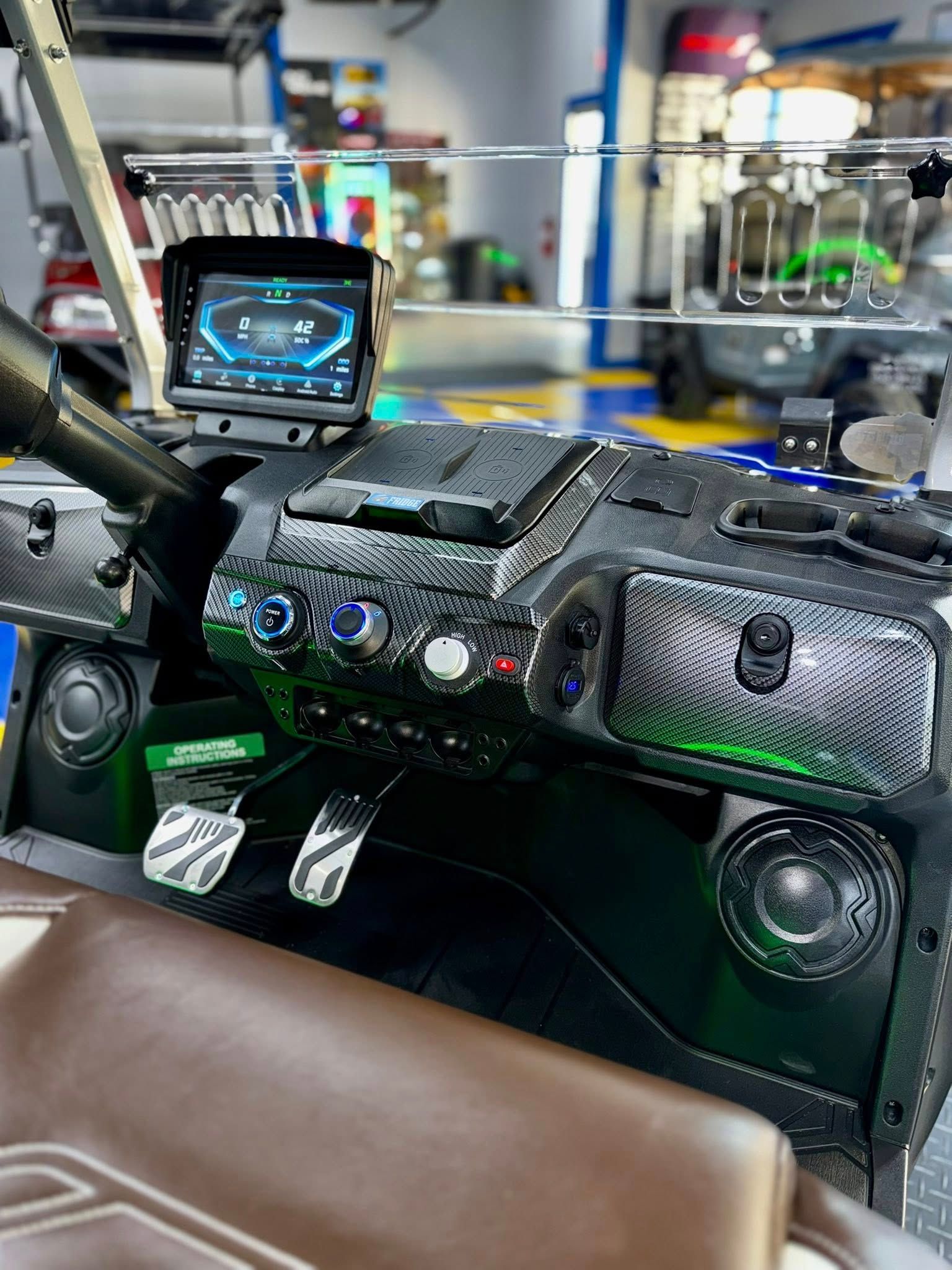 A close up of the dashboard of a golf cart in a garage.