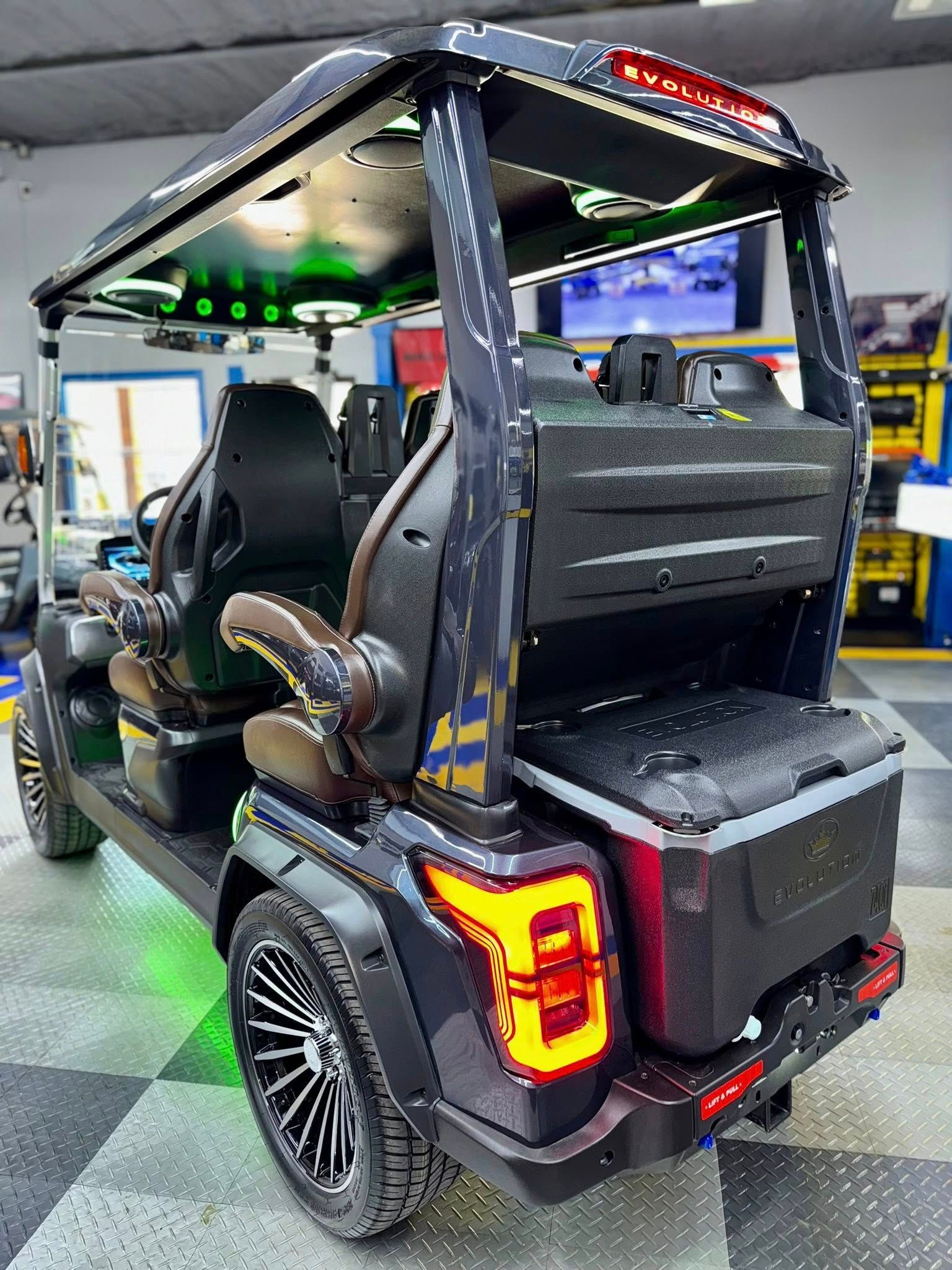 A black golf cart is parked in a garage.