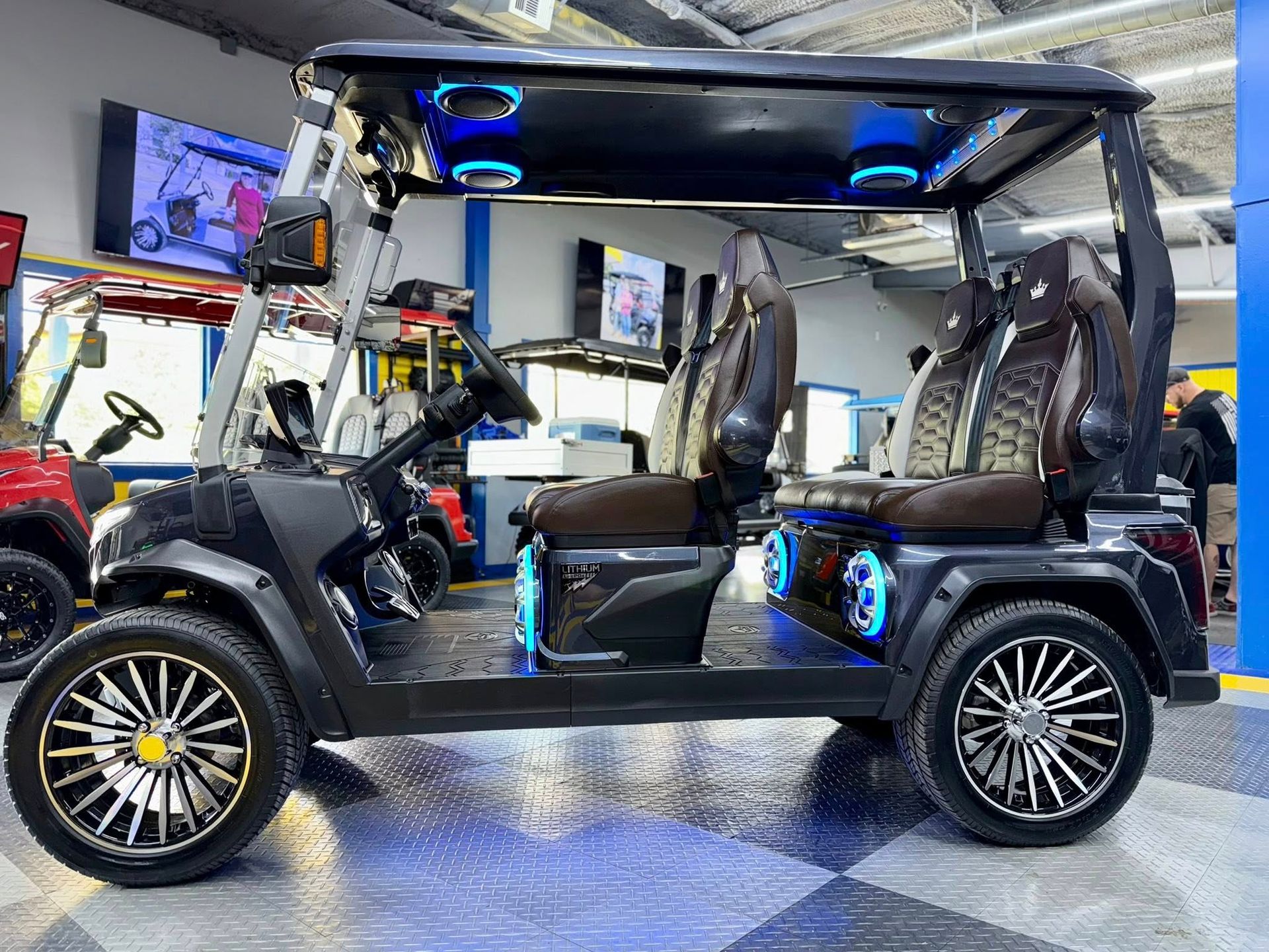A black golf cart is parked in a garage.