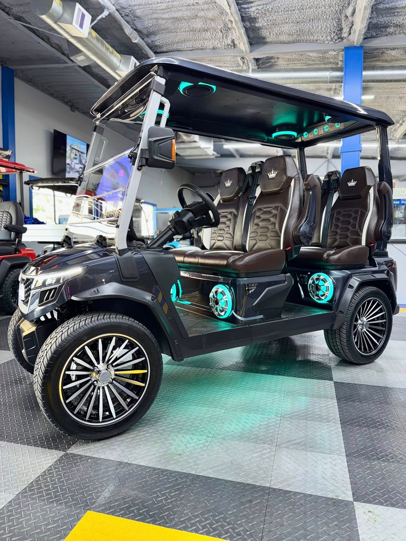 A black golf cart is parked in a garage.