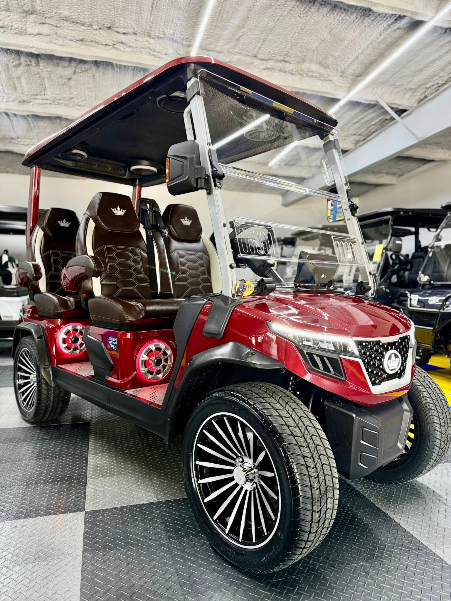 A red golf cart is parked in a garage.