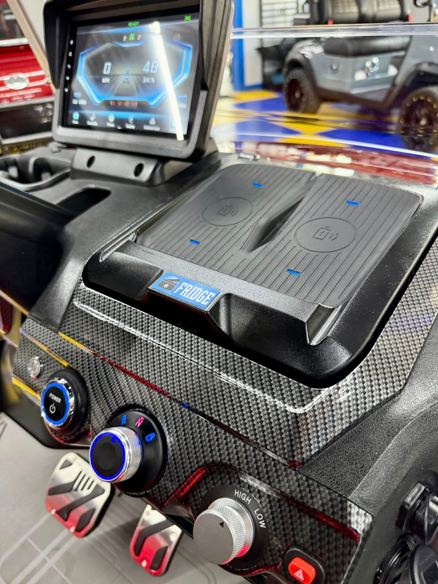A close up of the dashboard of a car with a wireless charger.