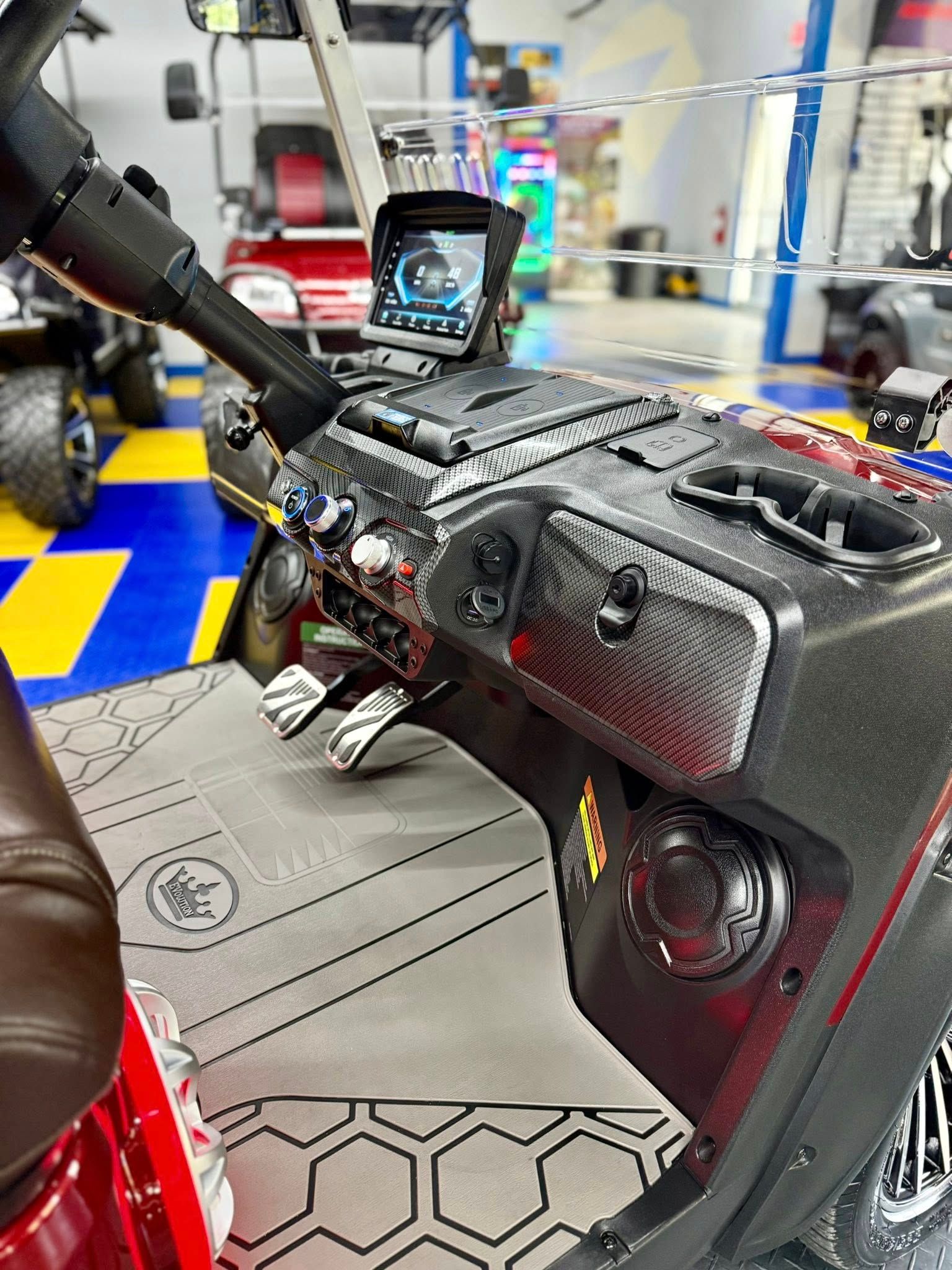 The interior of a golf cart is shown in a showroom.