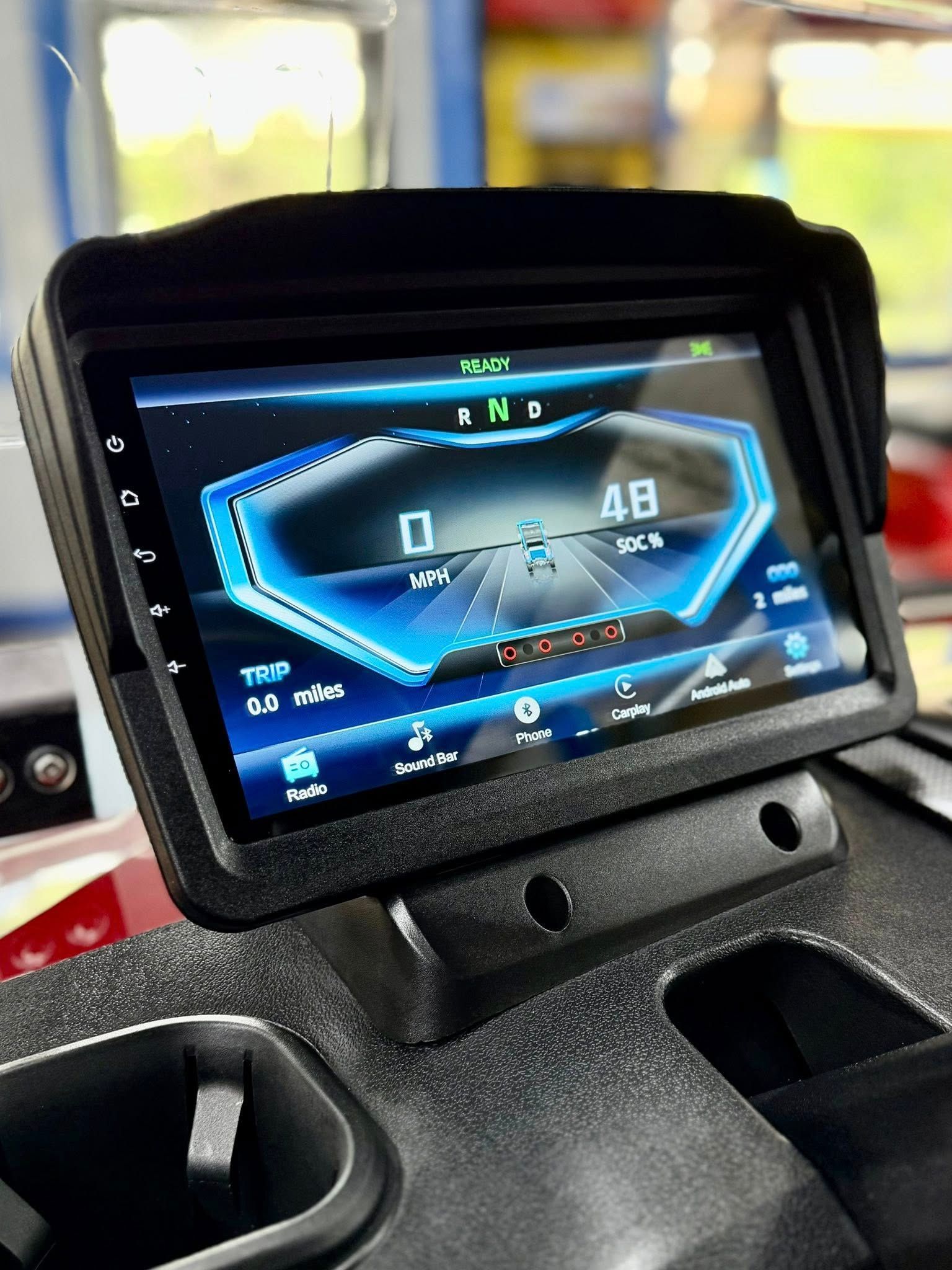 A close up of a touchscreen display on a vehicle.