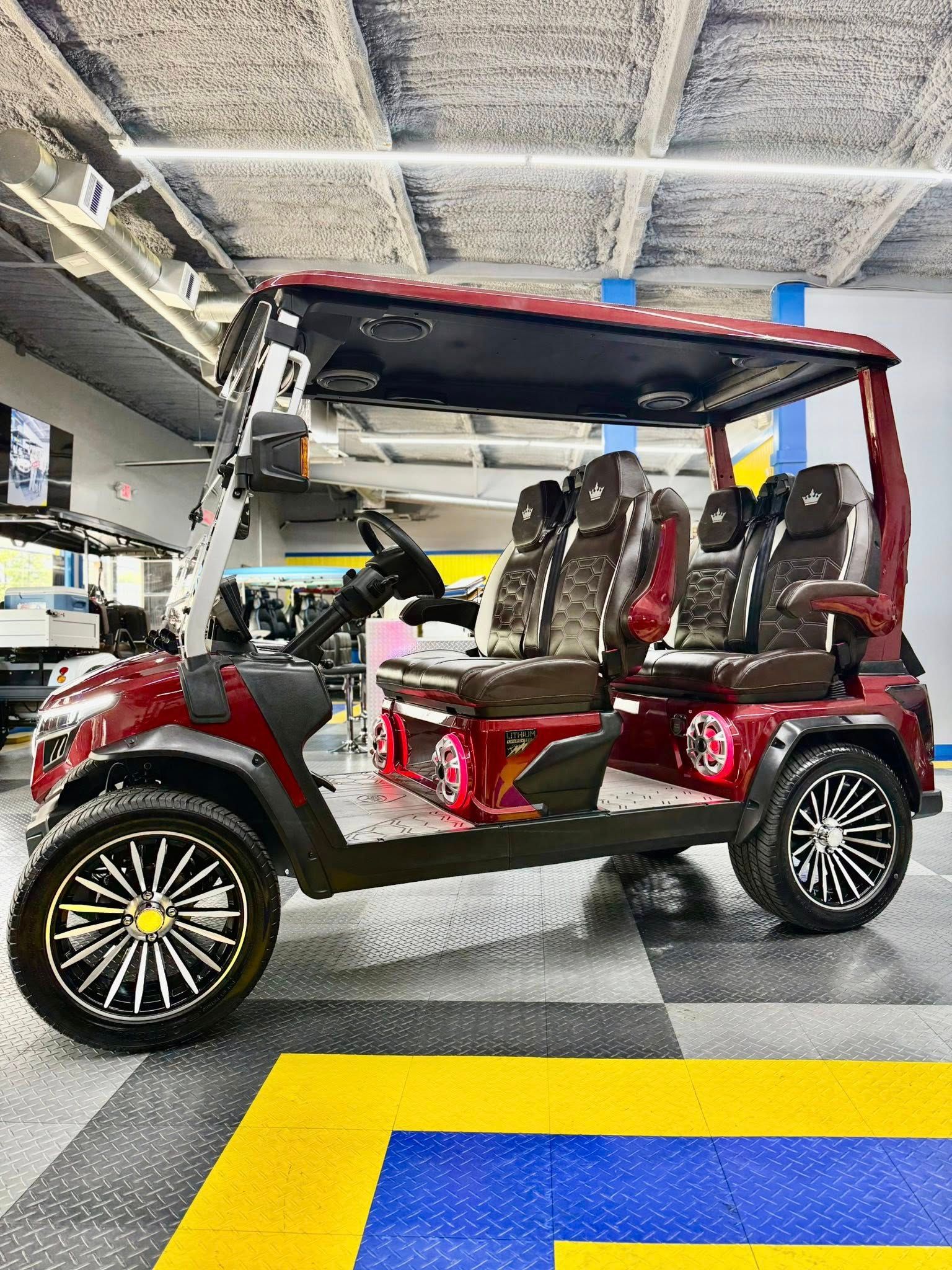 A red golf cart is parked in a garage.