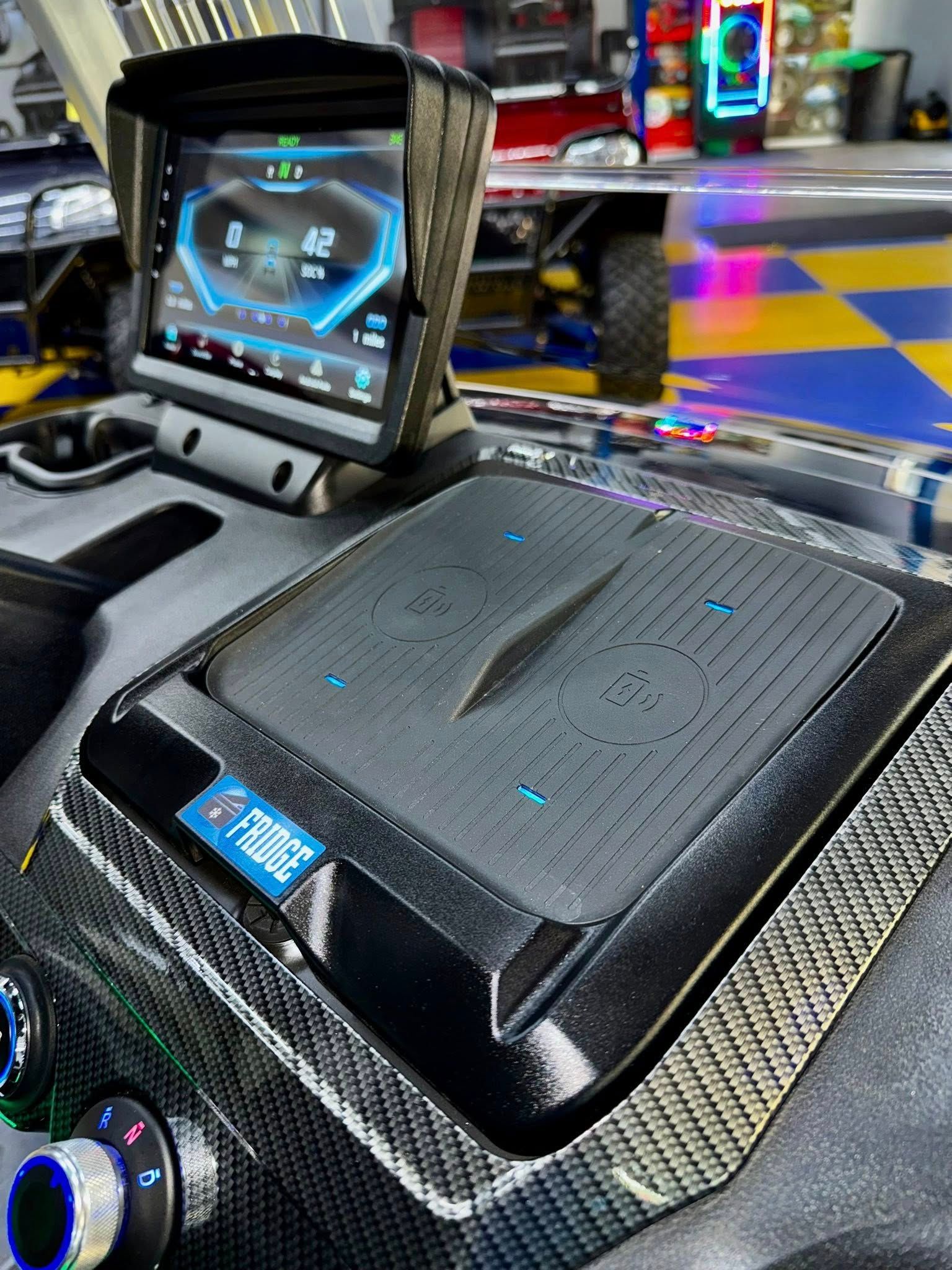 A black box with a screen on top of it is sitting on top of a table.