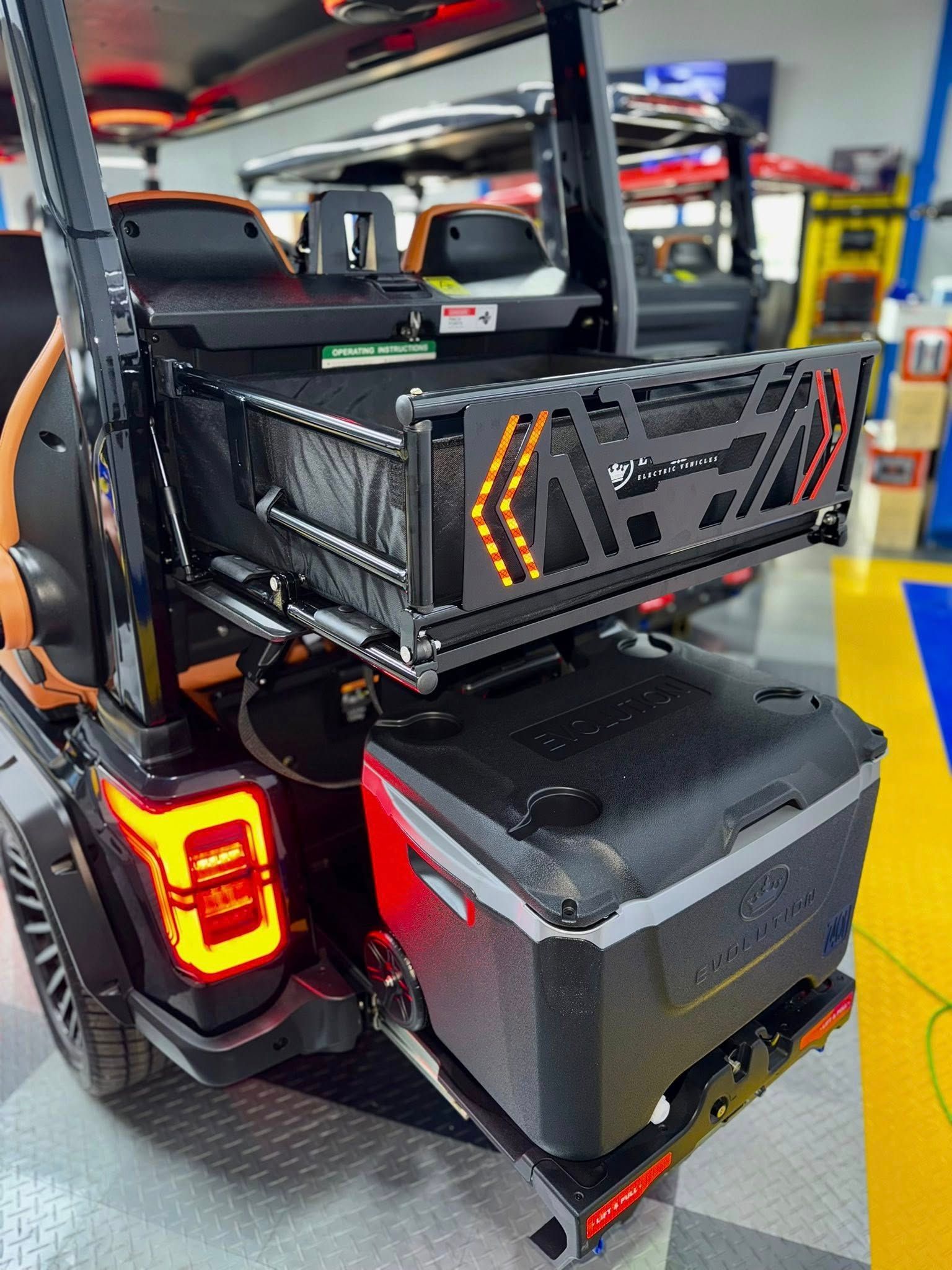 Black Jeep Wrangler with cargo carrier and cooler attached to the back.