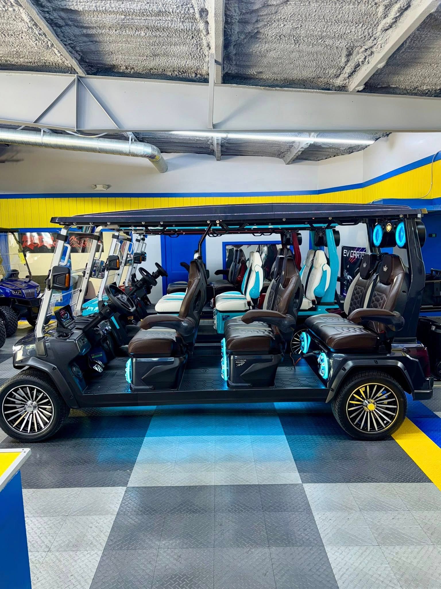 Eight-seat, black luxury golf cart with brown and teal accents, in a showroom.
