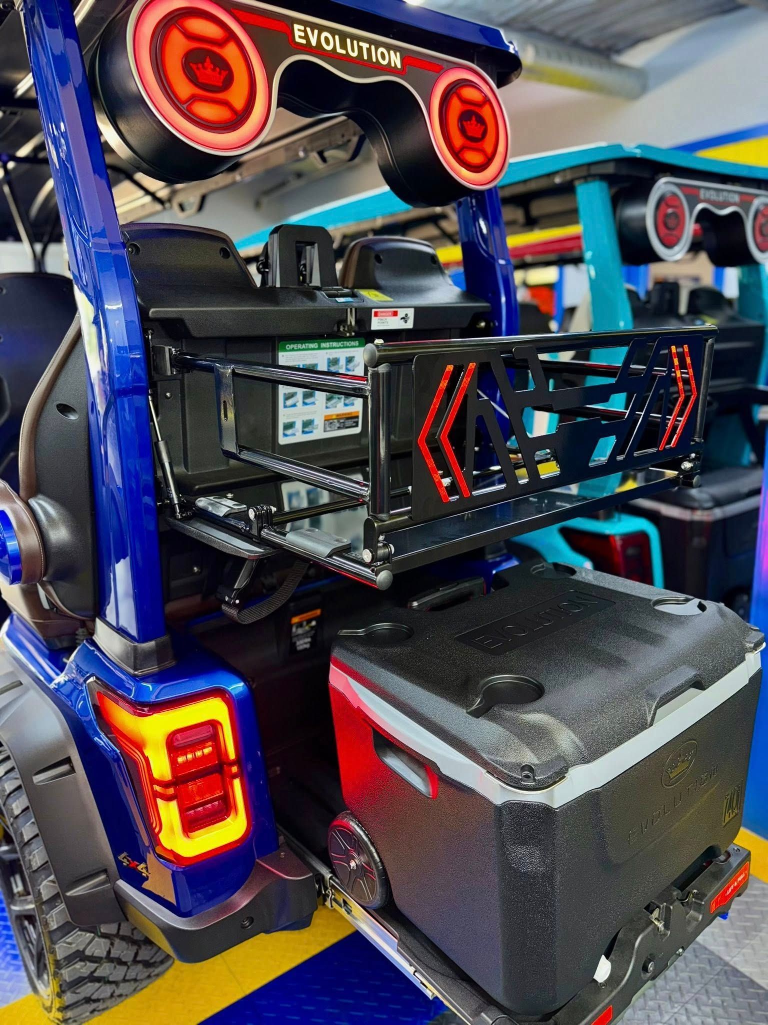 Blue golf cart back with equipment: lidar, cooler, and red accents.