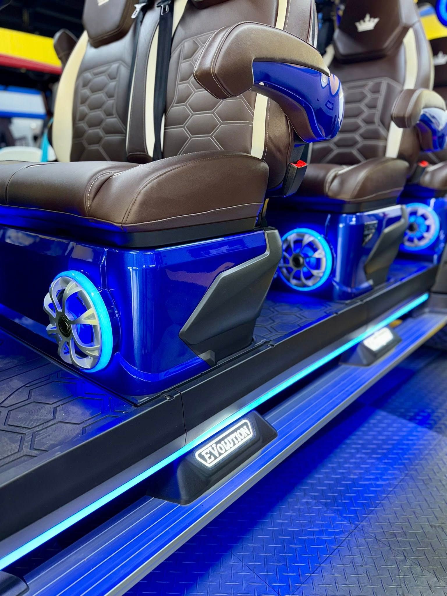 Blue and brown luxury ride seats with neon lights.