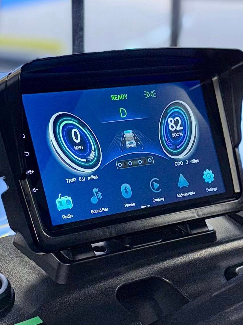 Car dashboard with digital speedometer at 82 mph. Blue display, black visor.