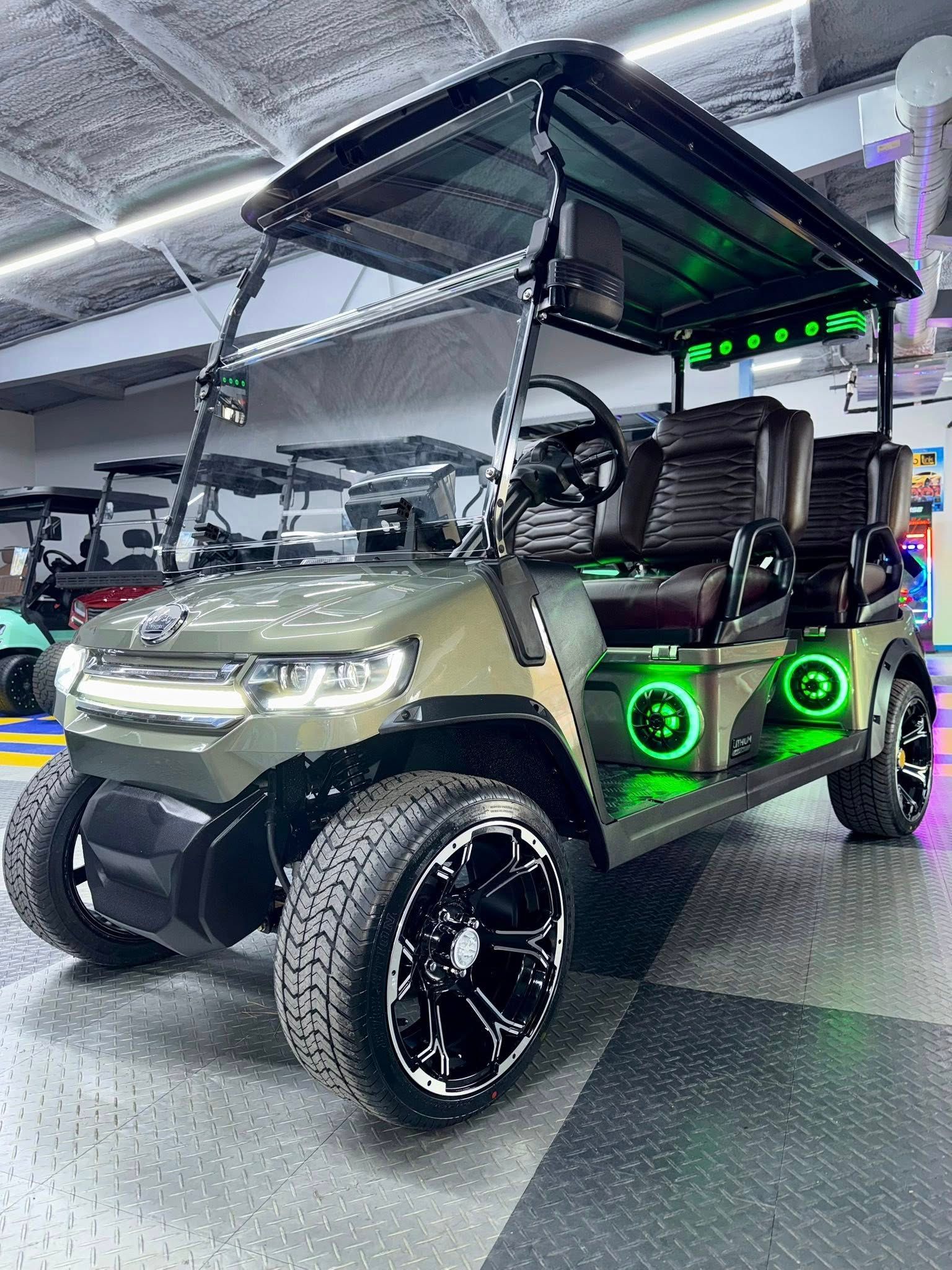 Camouflage golf cart with black rims and green underglow lights.