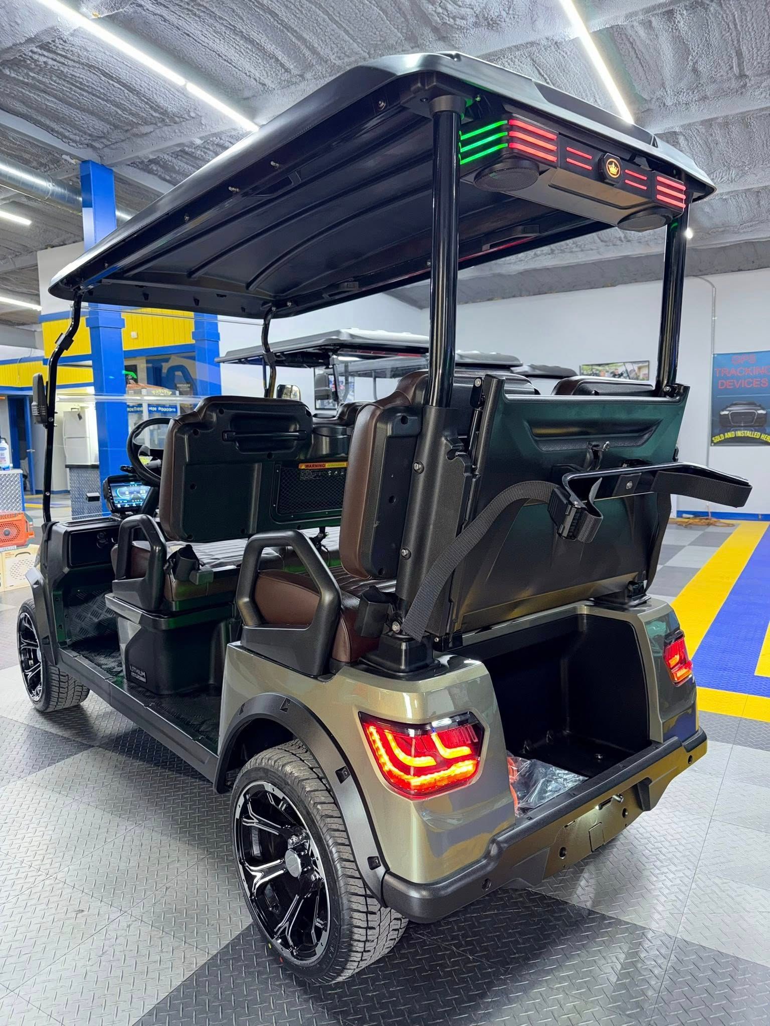 Green and black golf cart with tinted roof, black wheels, and taillights.