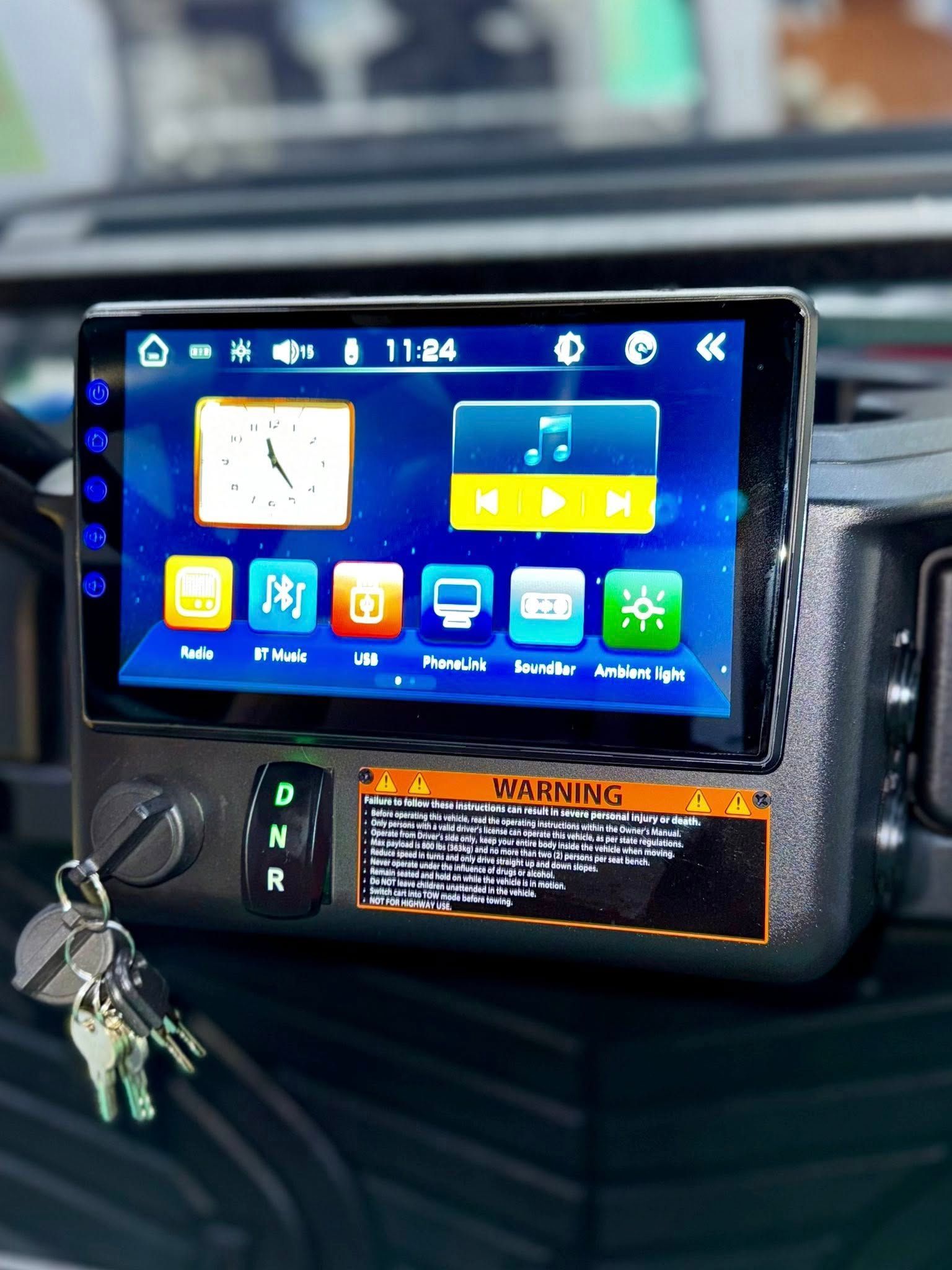 Dashboard with touchscreen, keys, and warning label.