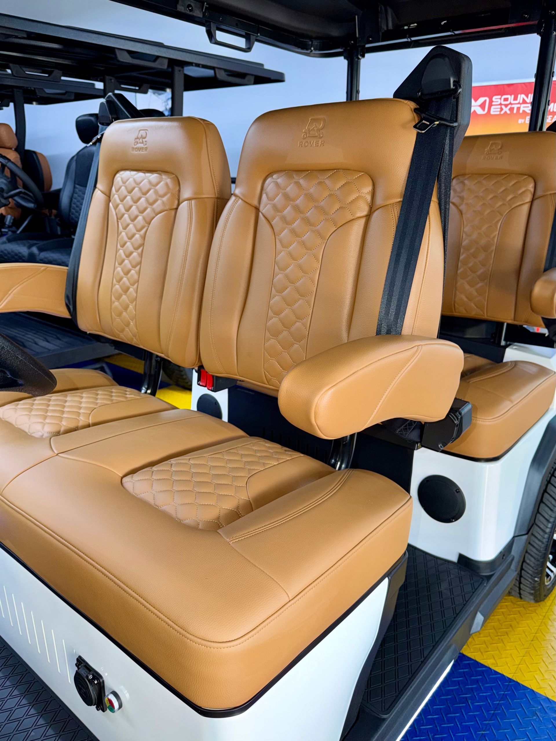 Tan leather captain’s seats with diamond stitching inside a vehicle interior