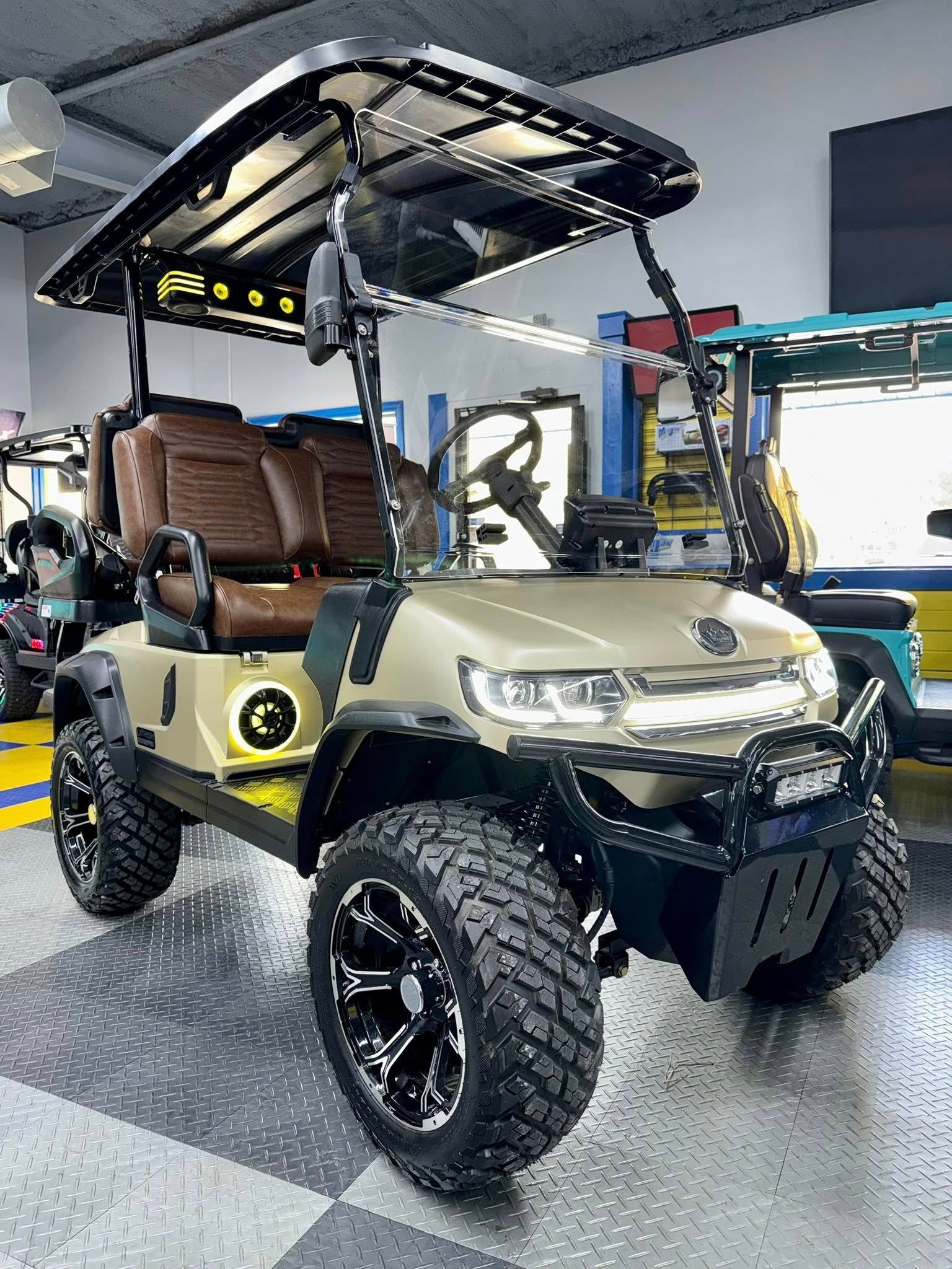 Olive green golf cart with black accents, rugged tires, and brown seats.