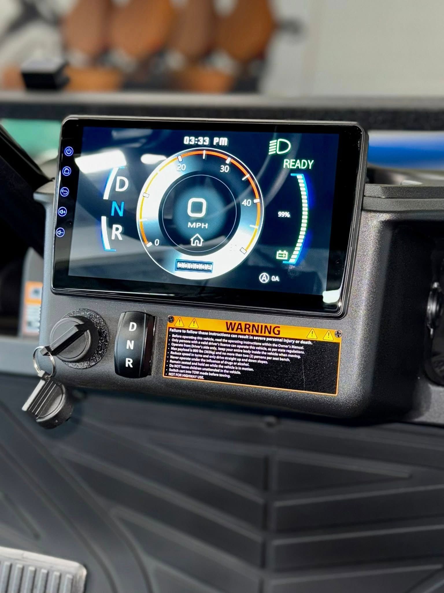 Dashboard display in a vehicle showing gauges and gear selector.