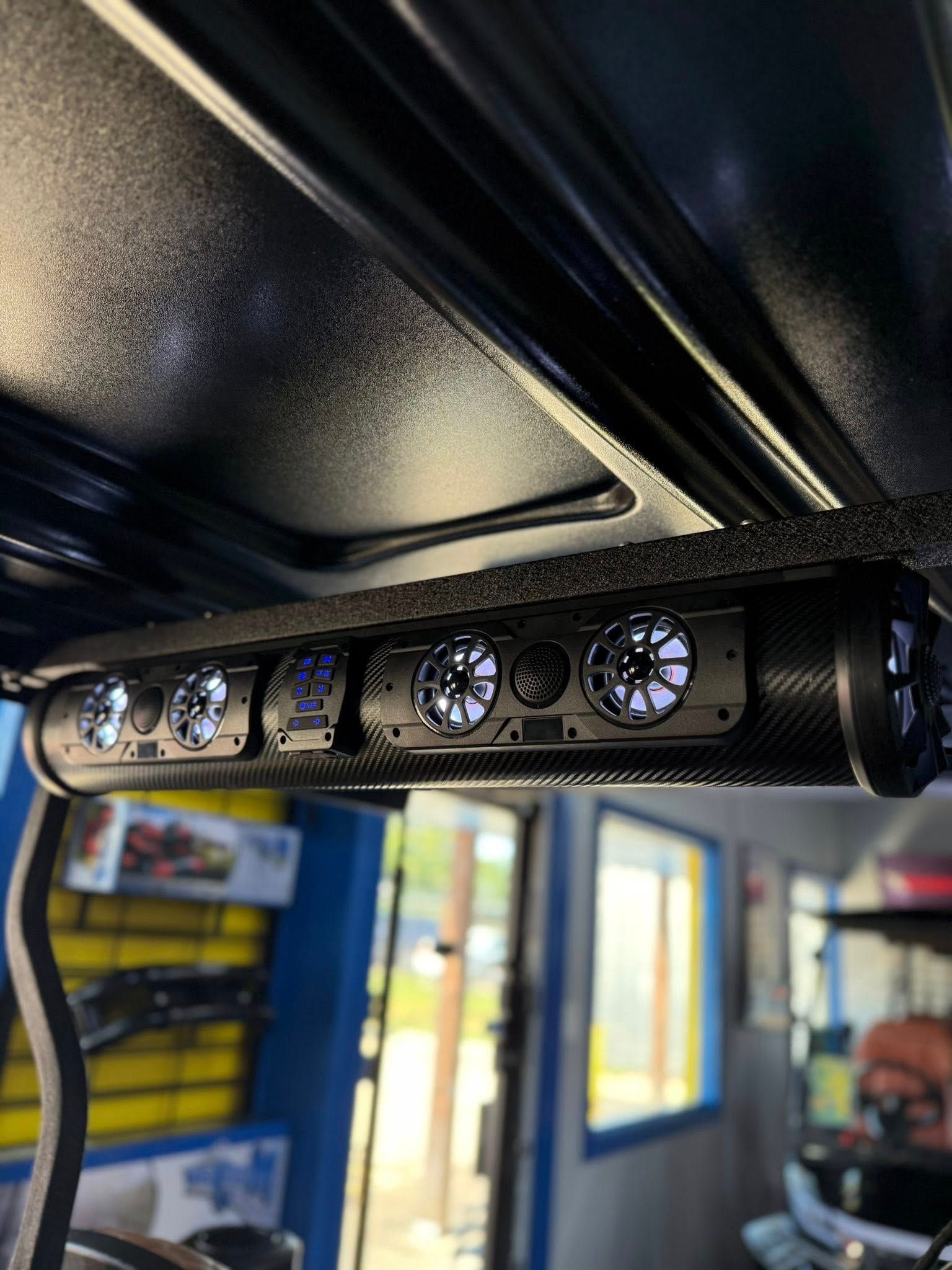 Black golf cart overhead soundbar with blue LED lights.