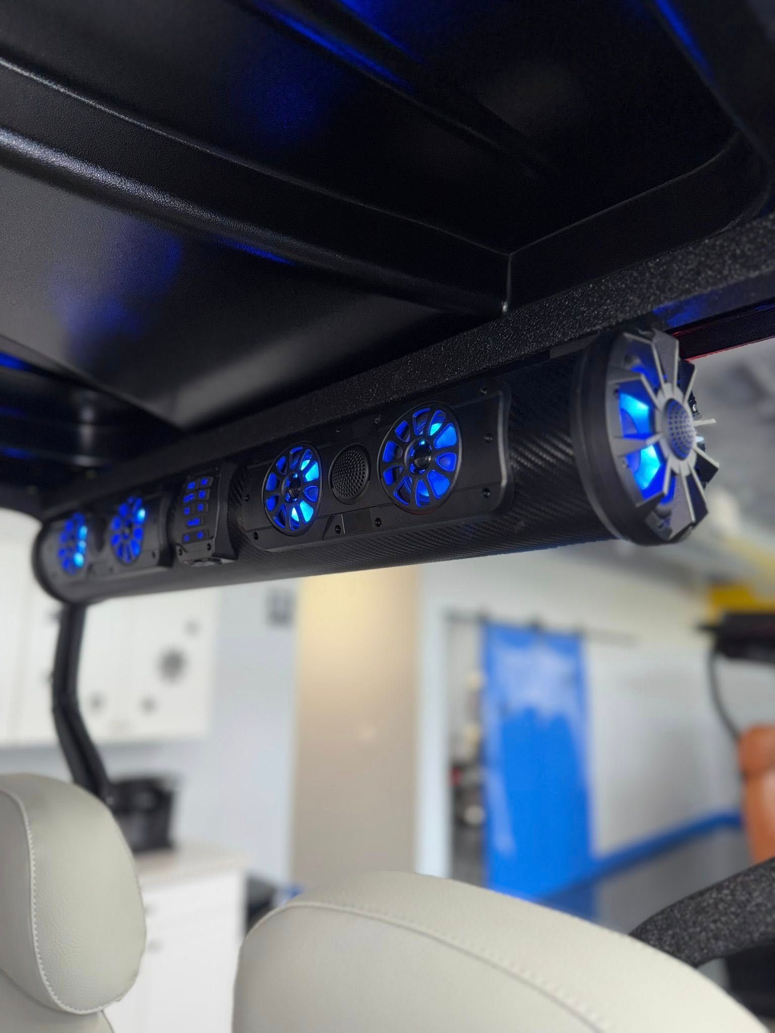 Golf cart soundbar with blue LED lights installed on the roof.