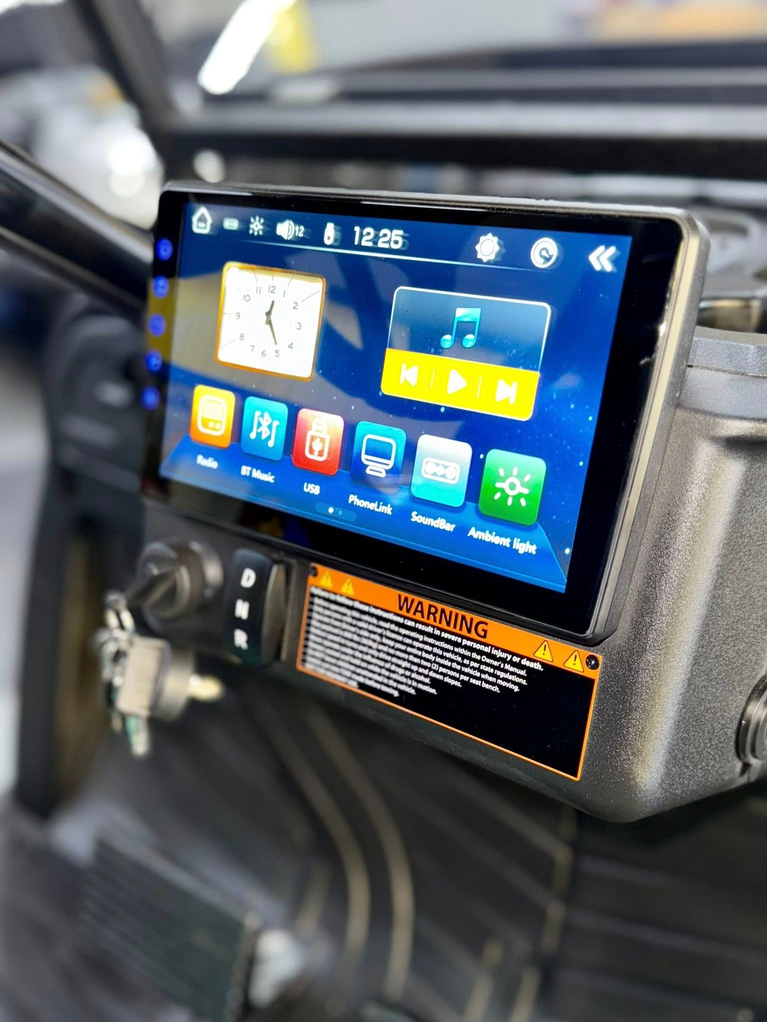 A cart's dashboard with a touchscreen display showing various icons, including clock and music symbols.