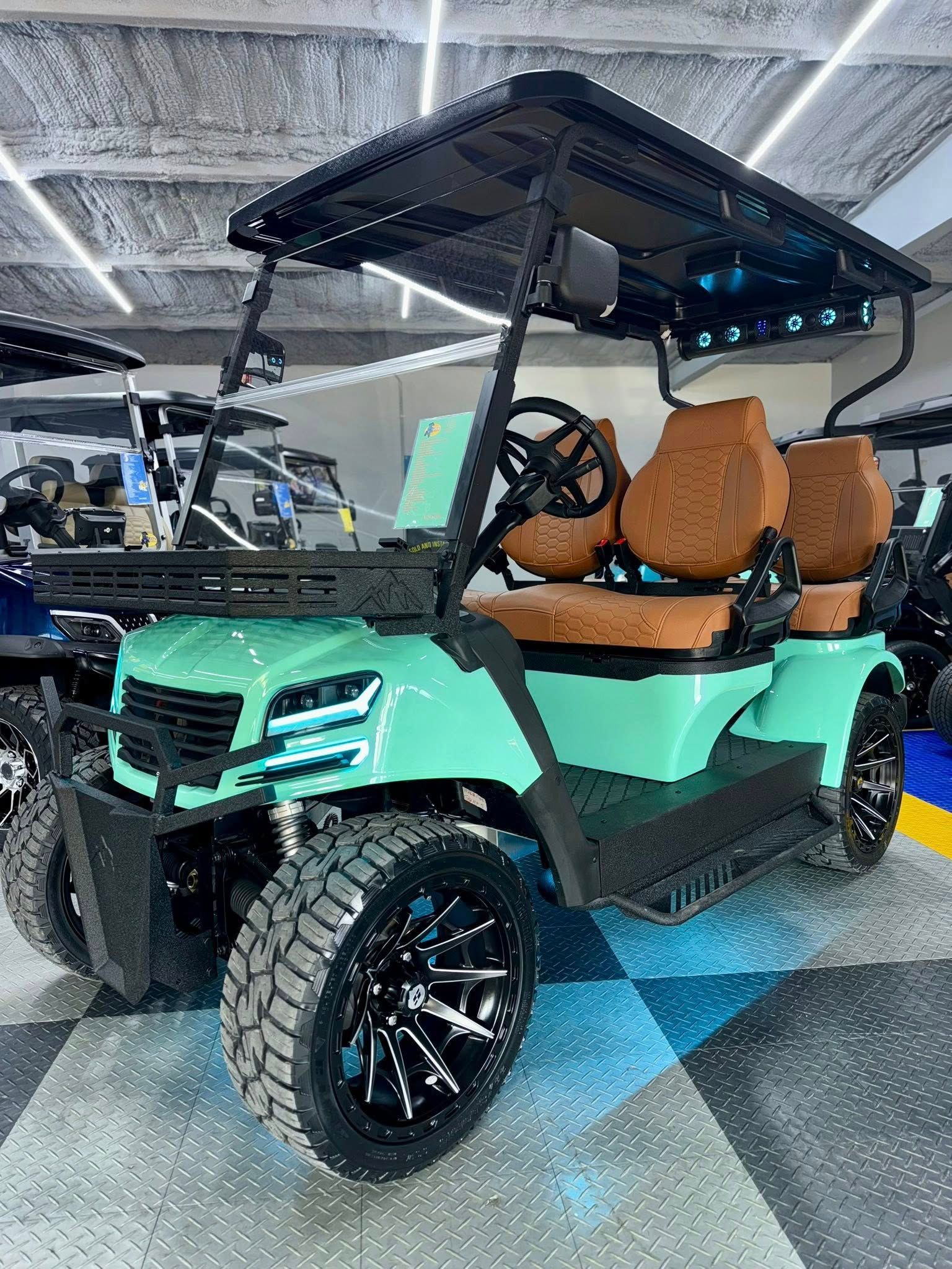 Mint green golf cart with black accents, brown seats, and off-road tires.