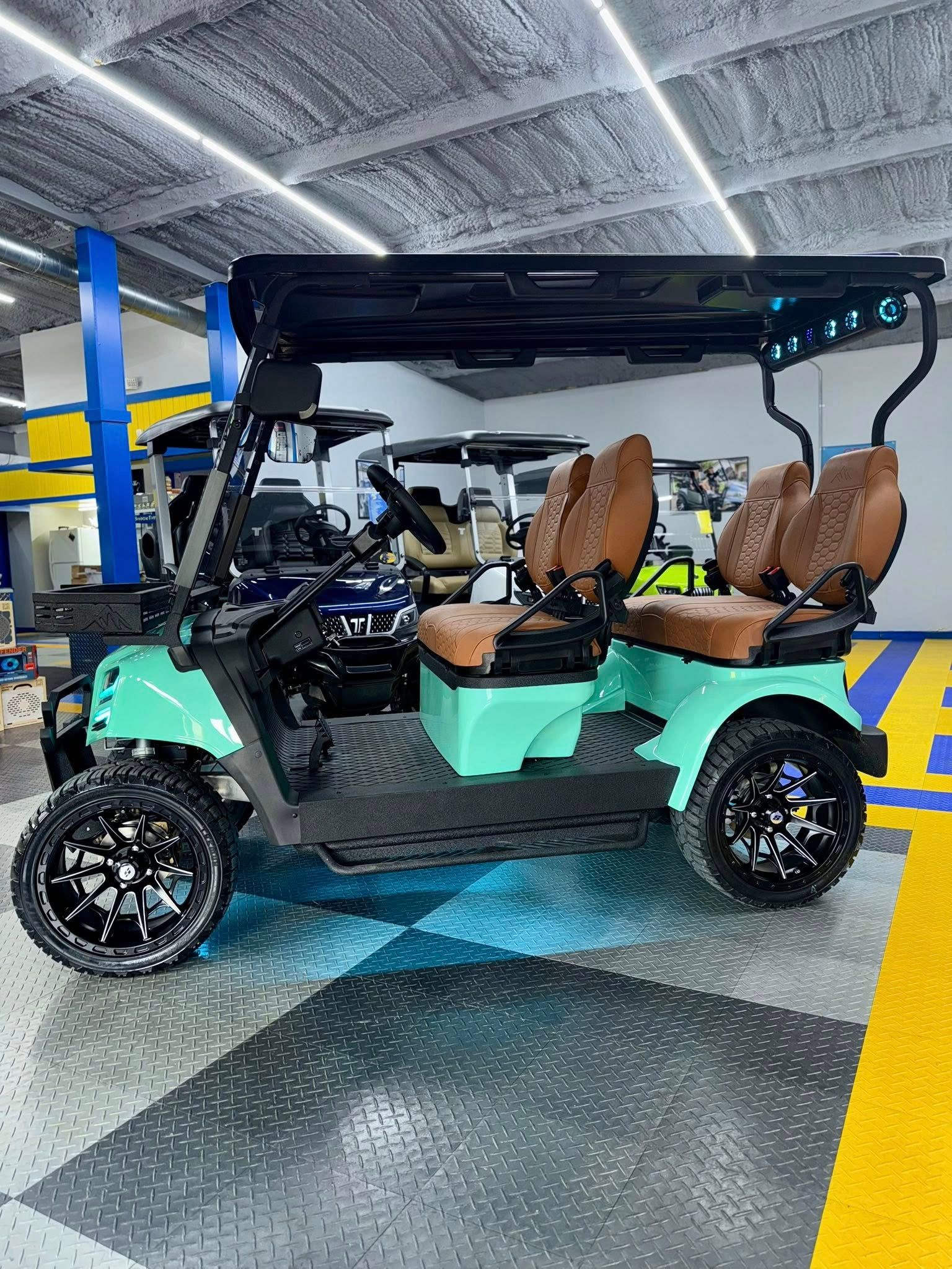Mint green golf cart with brown seats, black wheels, and a black roof.