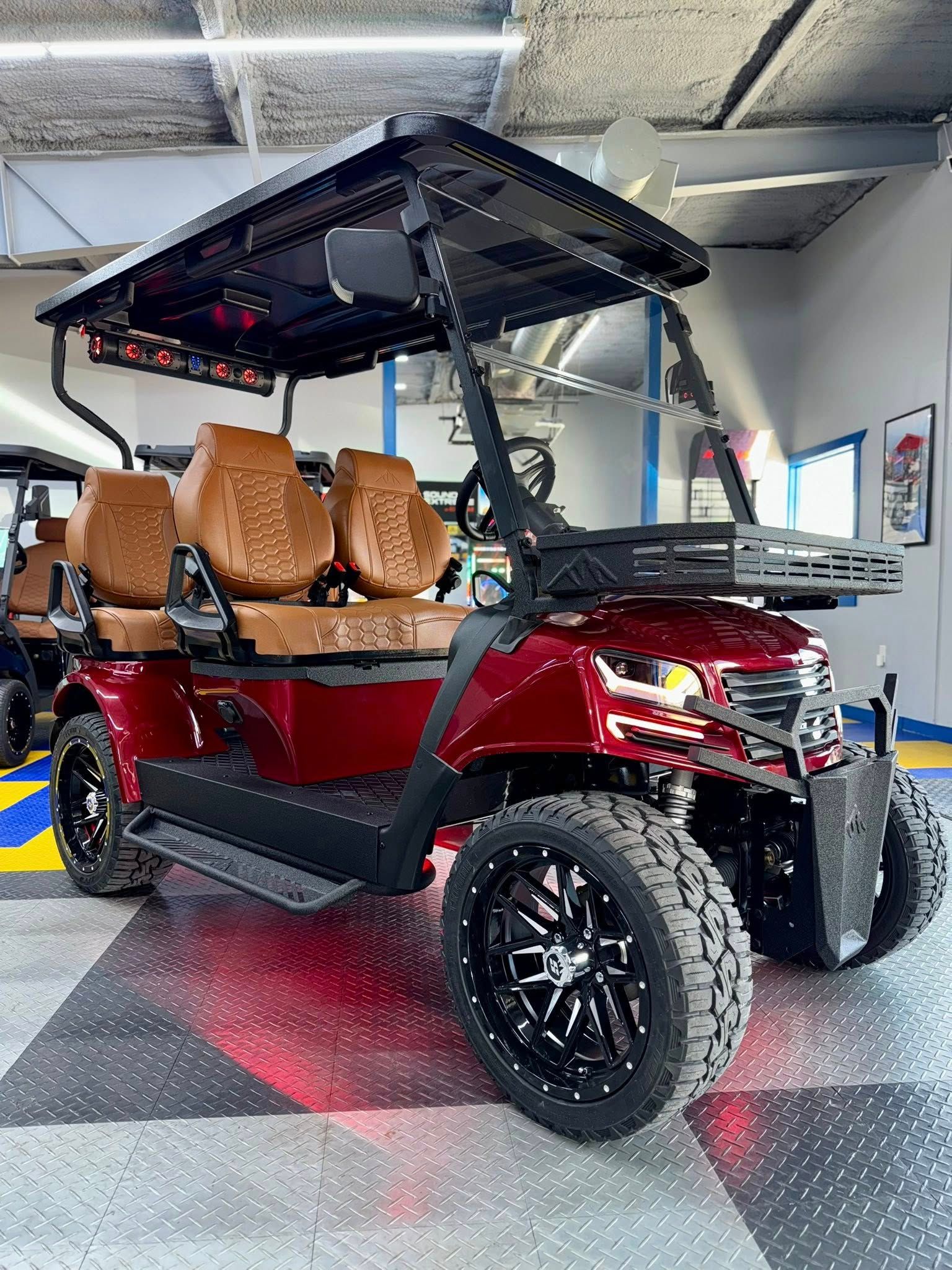 Red golf cart with brown seats, black wheels, and roof, in a garage.