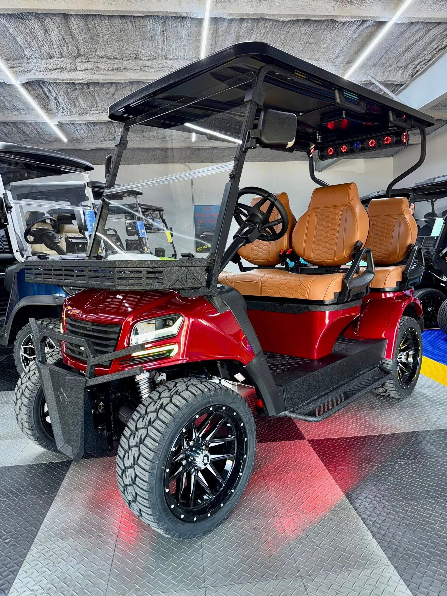 Red and black custom golf cart with tan seats, in a showroom.